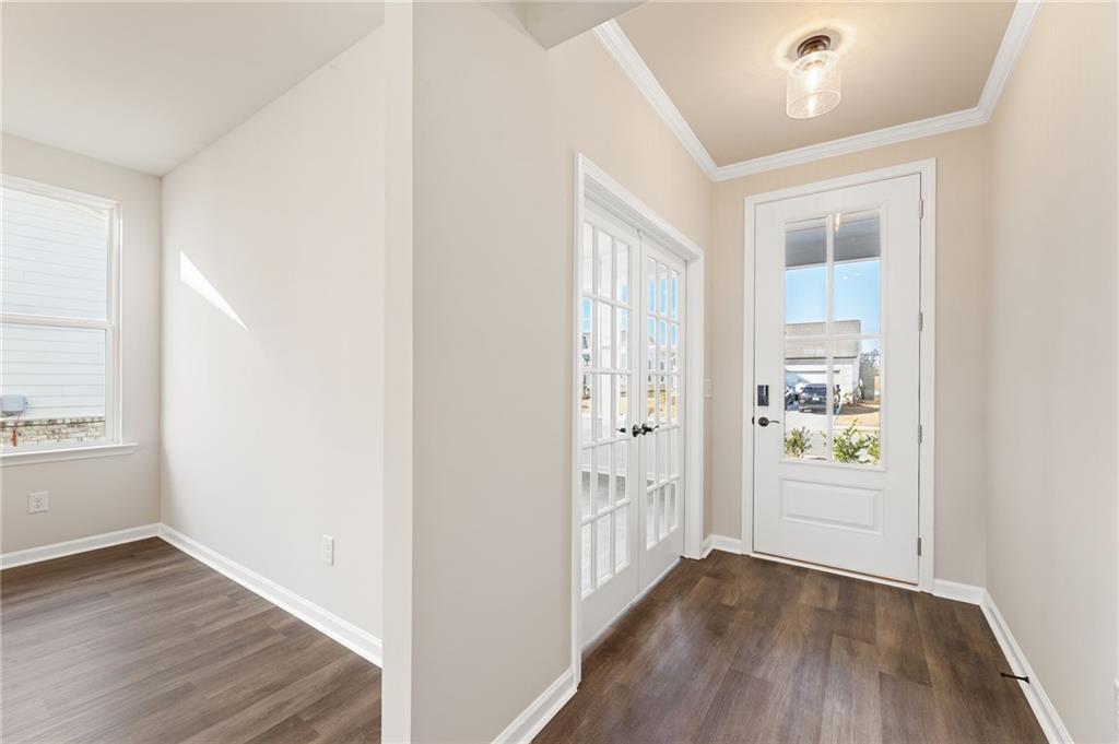 Bright entry foyer with hardwood floors, double doors, and glass front door in Davidson Homes The Glenwood A, Loganville, GA