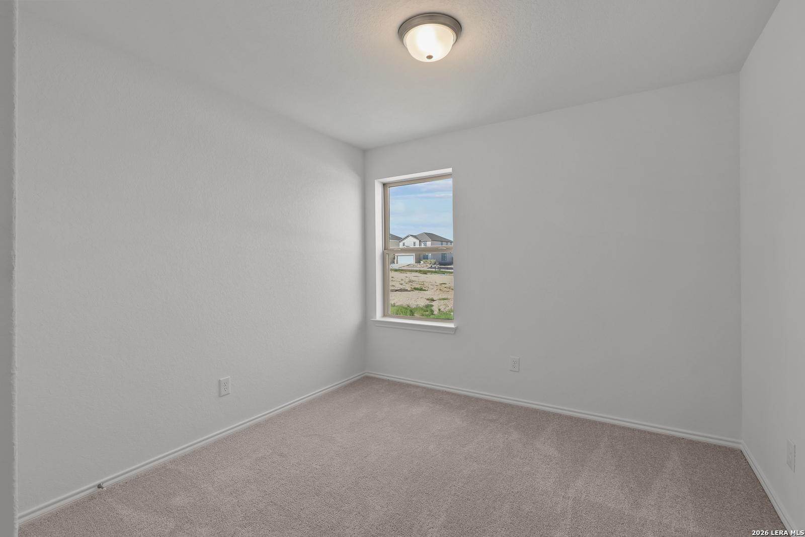 Bright, neutral-toned bedroom in The Brazos B floor plan by Davidson Homes in Agave, San Antonio, Texas.