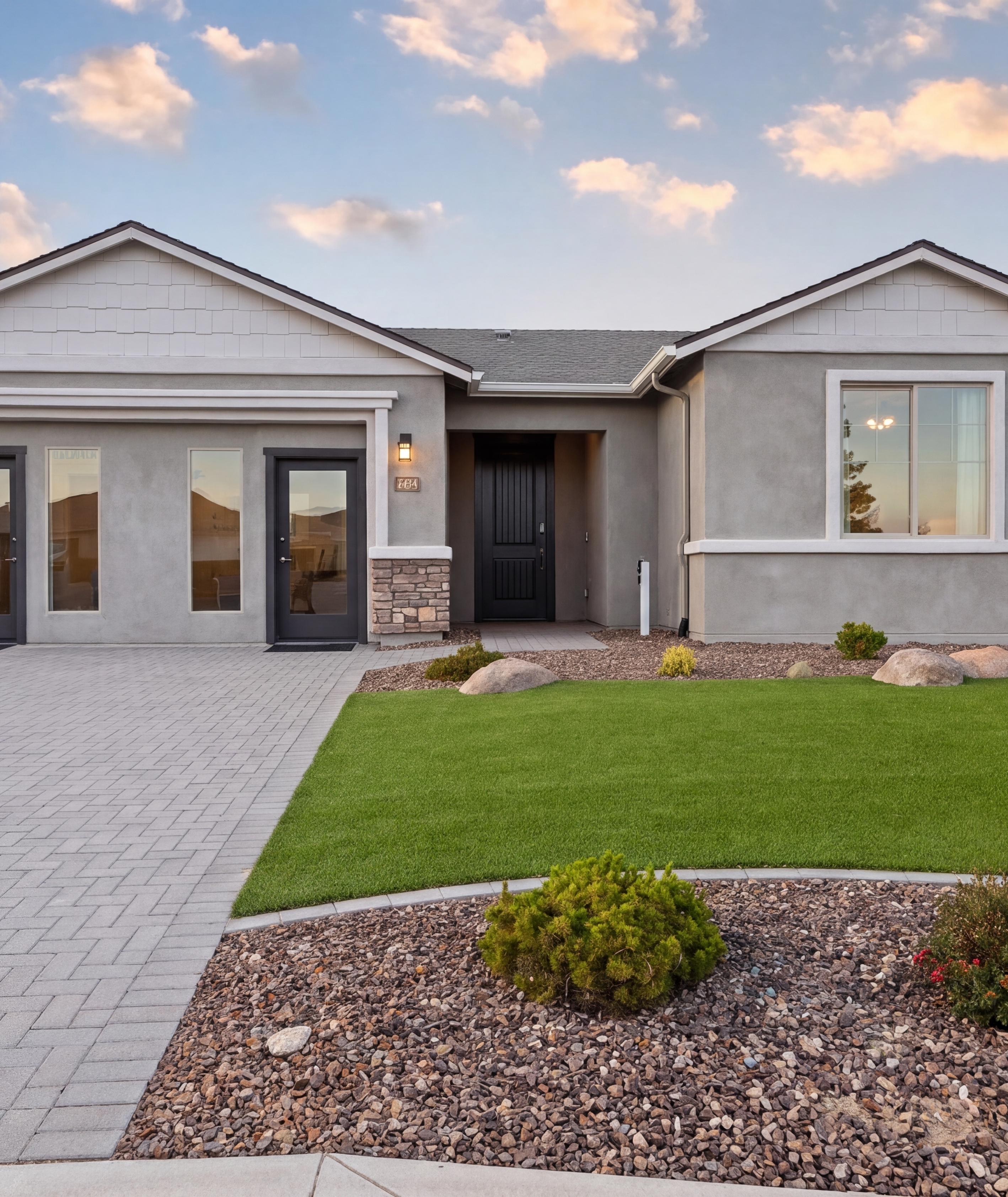 Davidson Homes sales center at North Ridge in Prescott Valley, Arizona featuring stone accents and a paved driveway.