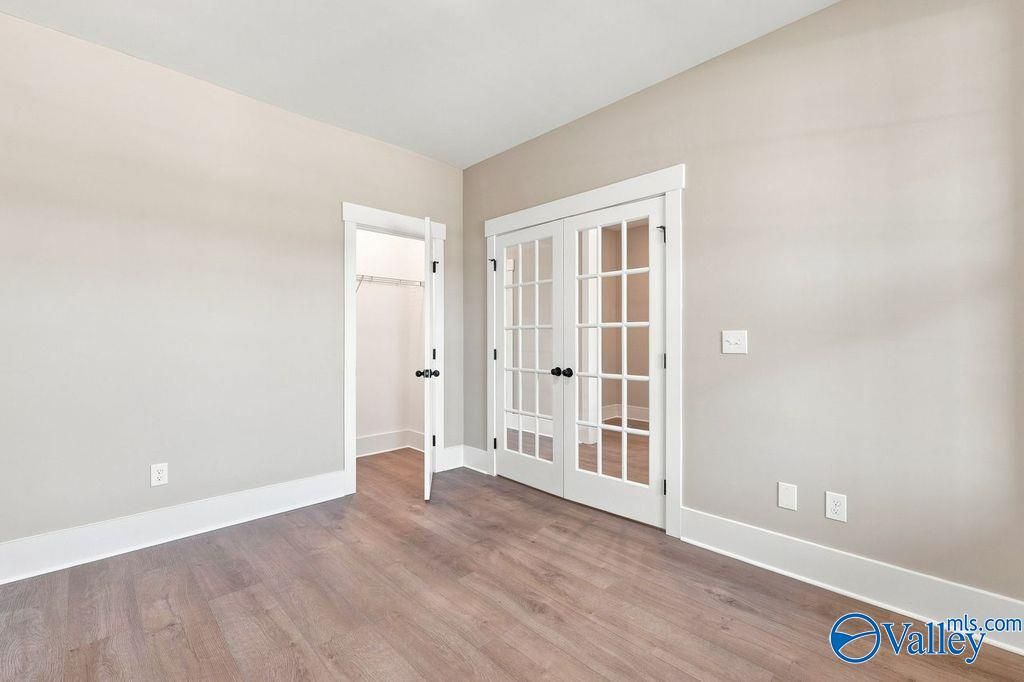 Bright home office or bedroom with French doors and walk-in closet in The Rockford floor plan, Cain Park, Hartselle, AL.