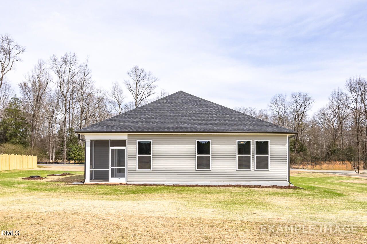 Single-story gray home with screened porch, double windows, and grassy yard in Woodland Crossing, Zebulon, North Carolina