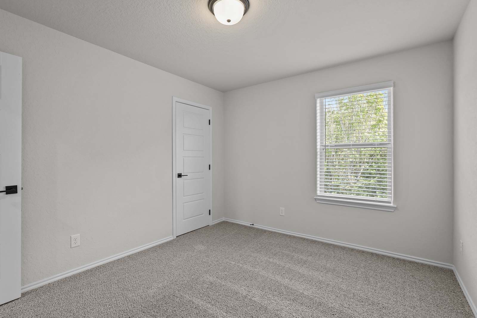 Bright, spacious bedroom in The Florence B home design by Davidson Homes featuring neutral carpet and natural light.