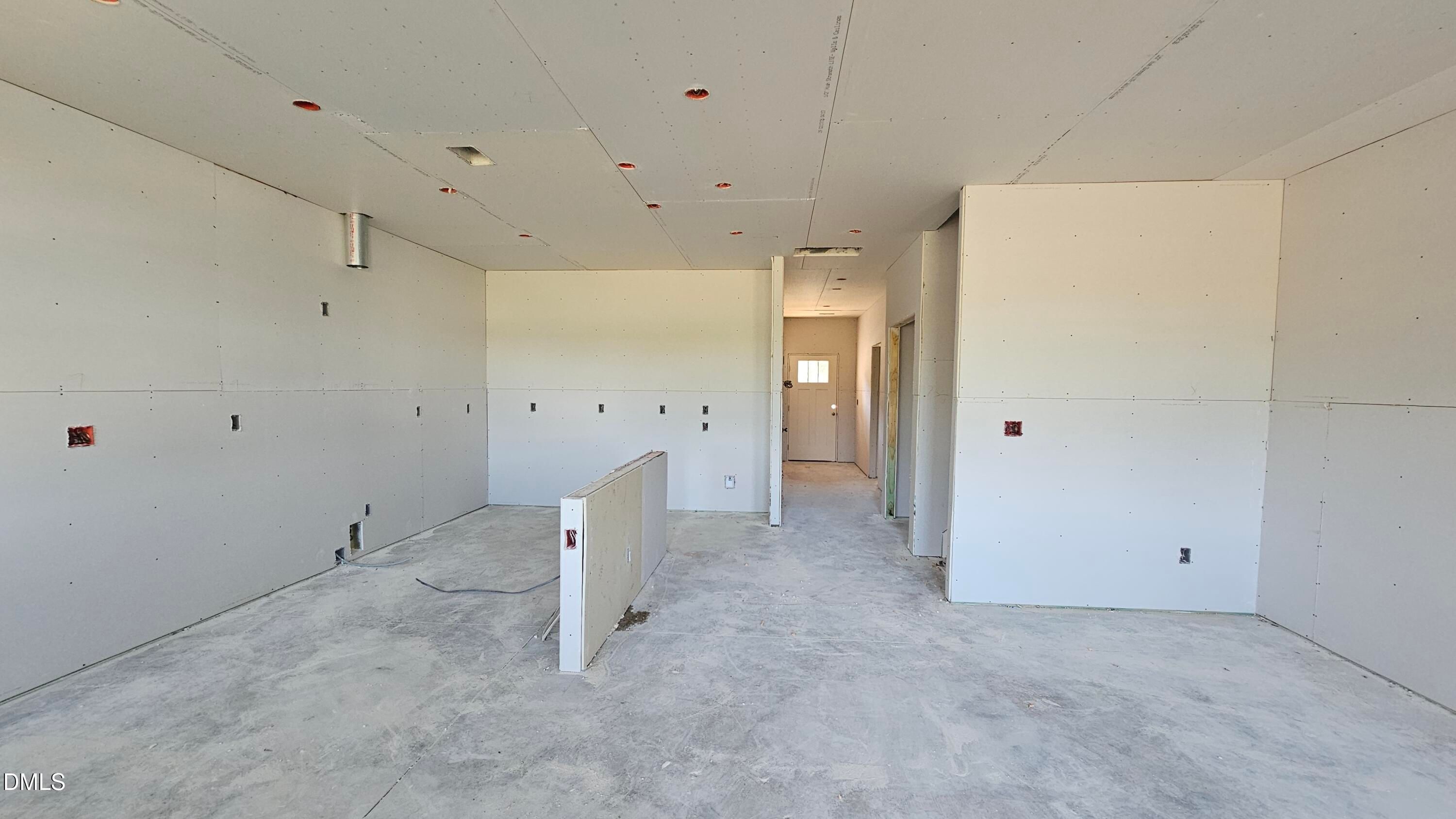 Unfinished open-concept interior of The Graham floor plan by Davidson Homes in Springvale, Fuquay-Varina, North Carolina.
