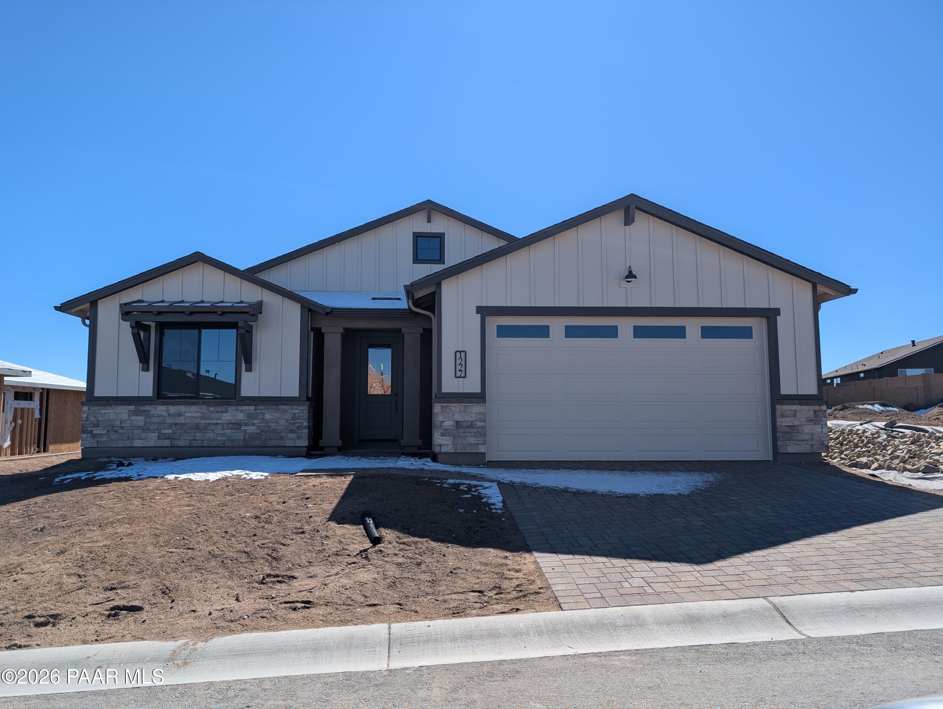 Modern single-story The Sheridan II G home with 3-car garage, horizontal siding, and stone accents in Prescott Arizona South Ranch