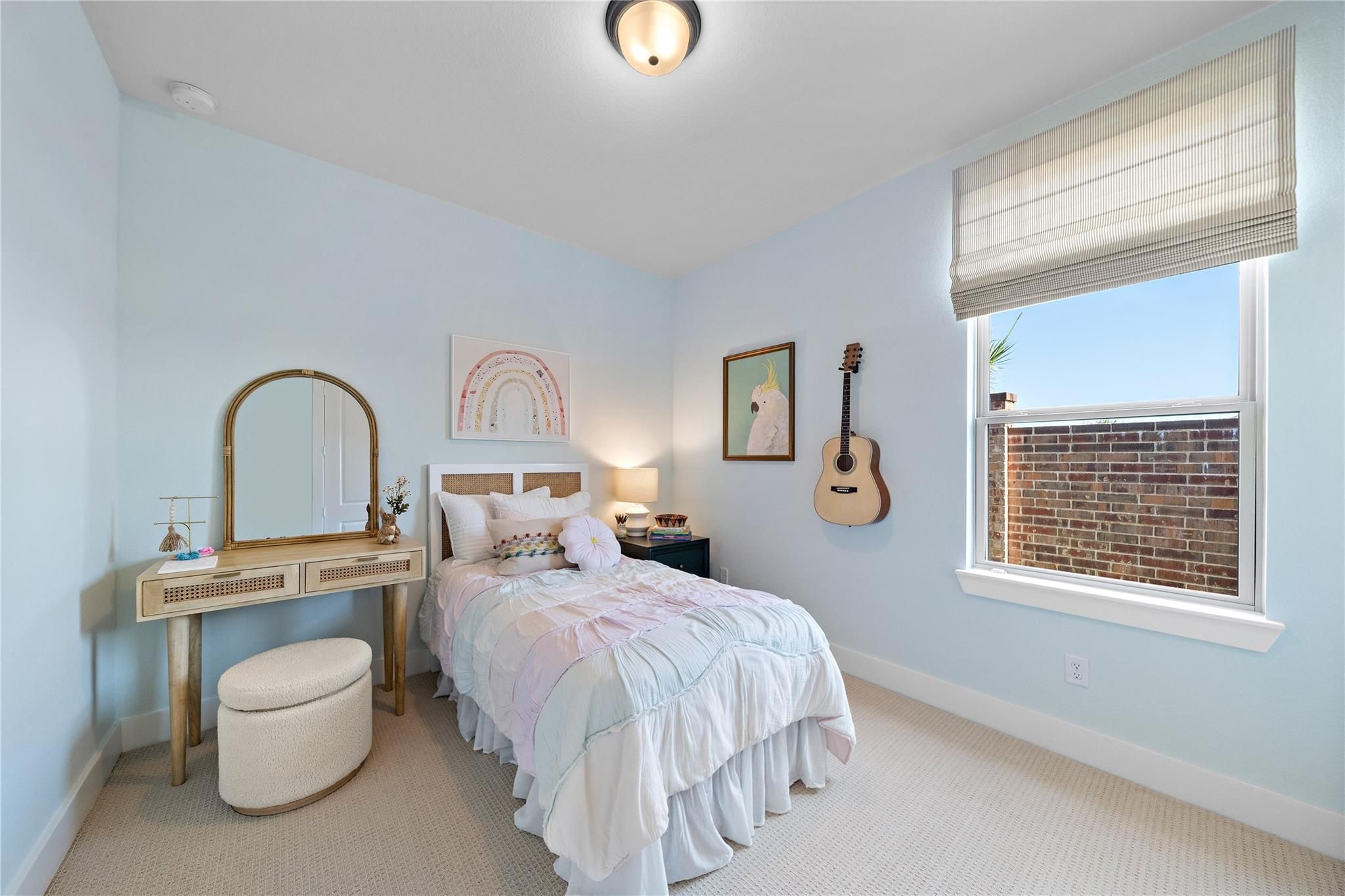 Bright pastel bedroom with vanity and large window in The Edward A floor plan by Davidson Homes in Lago Mar, Texas City