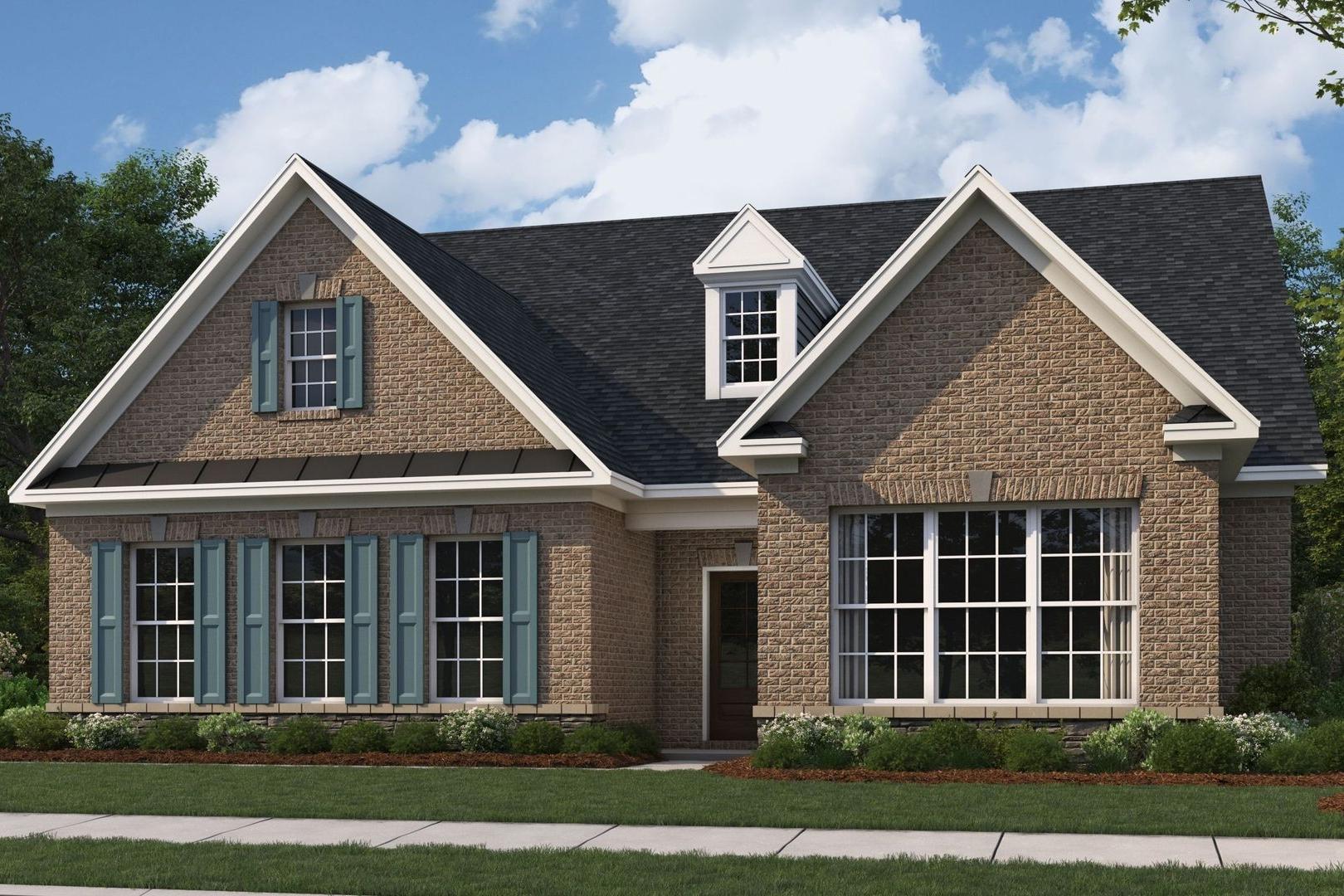 Two-story brick home elevation of The Oxford by Evermore Homes with blue shutters, gabled roof, and lush landscaping