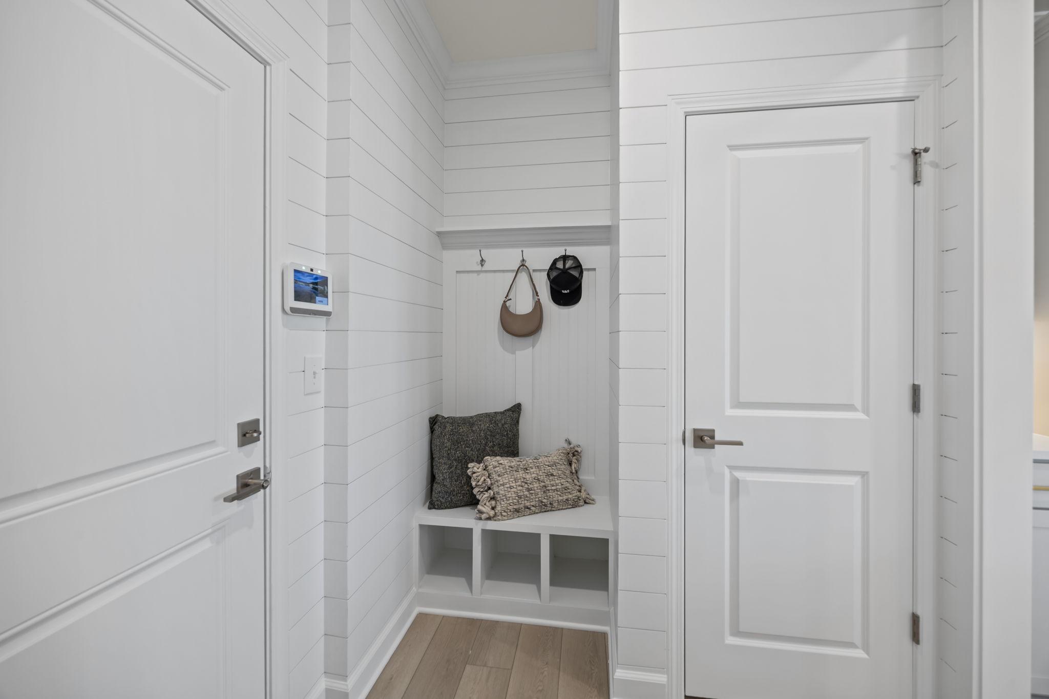 Mudroom bench with shiplap walls and storage cubbies at Springvale South in Fuquay-Varina, NC by Davidson Homes.