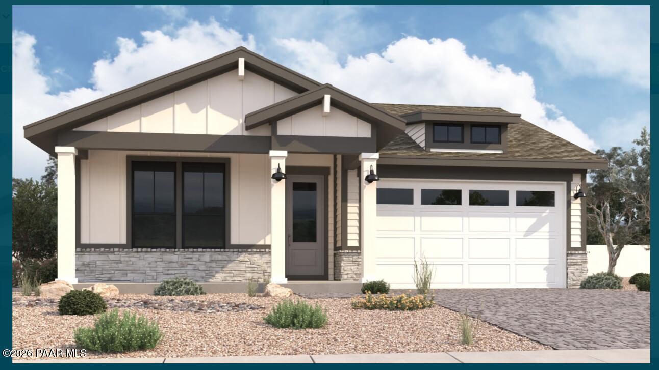Modern beige ranch-style home with 3-car garage, stone accents, desert xeriscape, and gabled roof in Prescott, Arizona