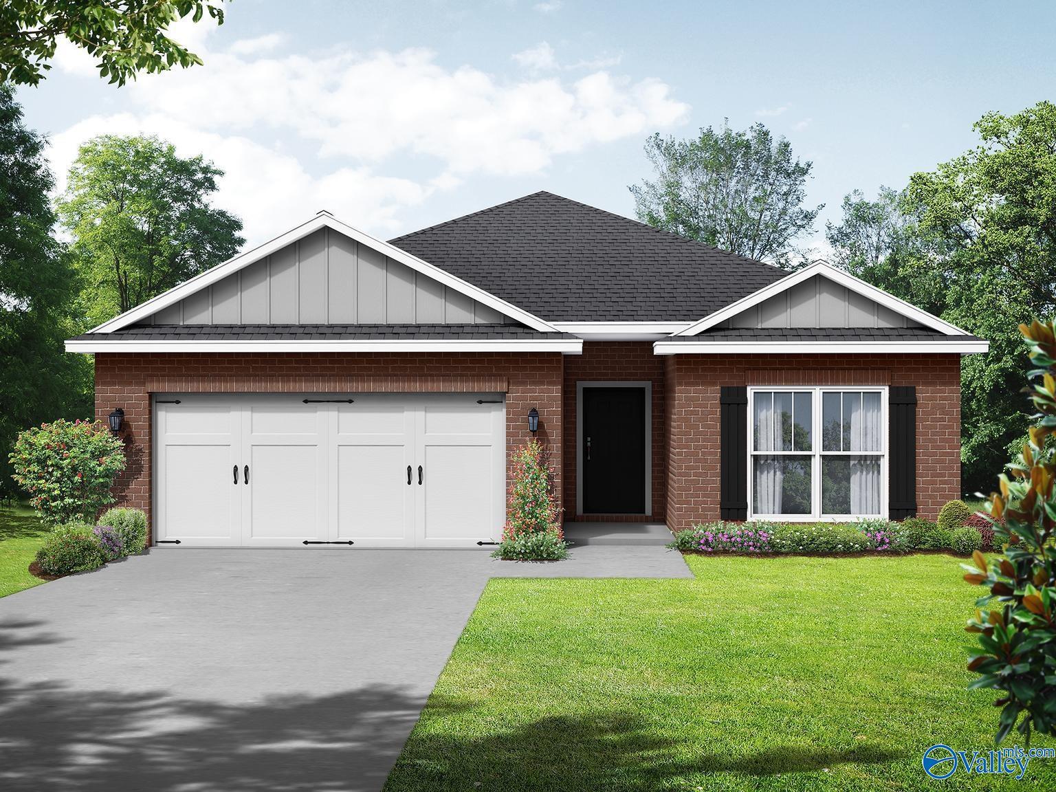 Single-story brick ranch home with 2-car garage, gabled roof, and landscaped yard by Davidson Homes The Everett in Wood Trail, Toney, Alabama