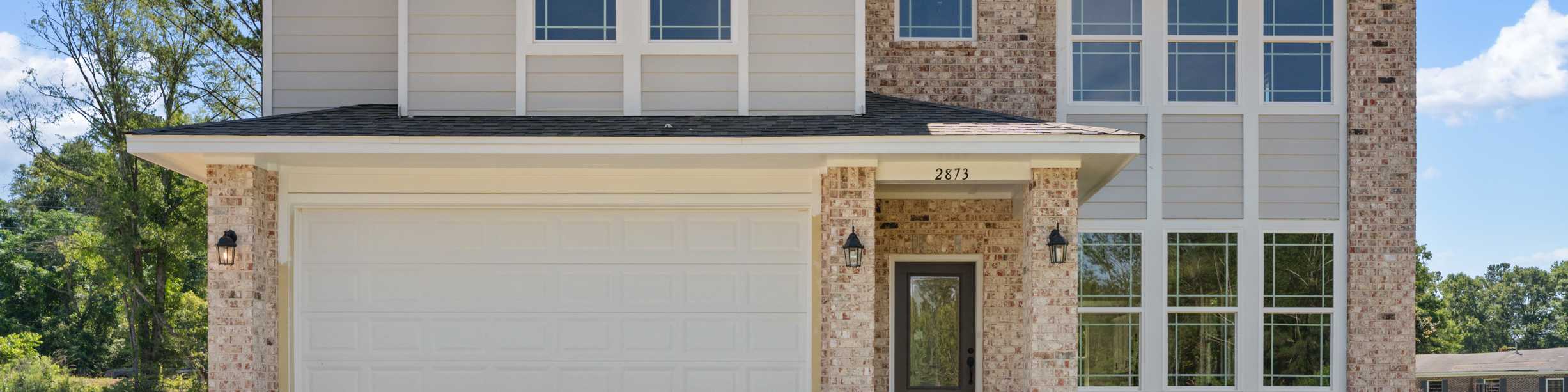 Two-story brick and siding home exterior at Links Crossing in Auburn, Alabama, built by Davidson Homes.