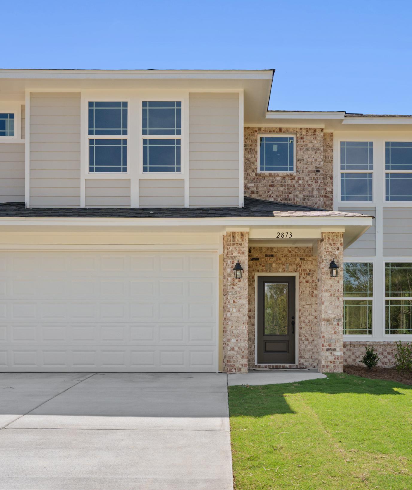 Two-story brick and siding home exterior at Links Crossing in Auburn, Alabama, built by Davidson Homes.