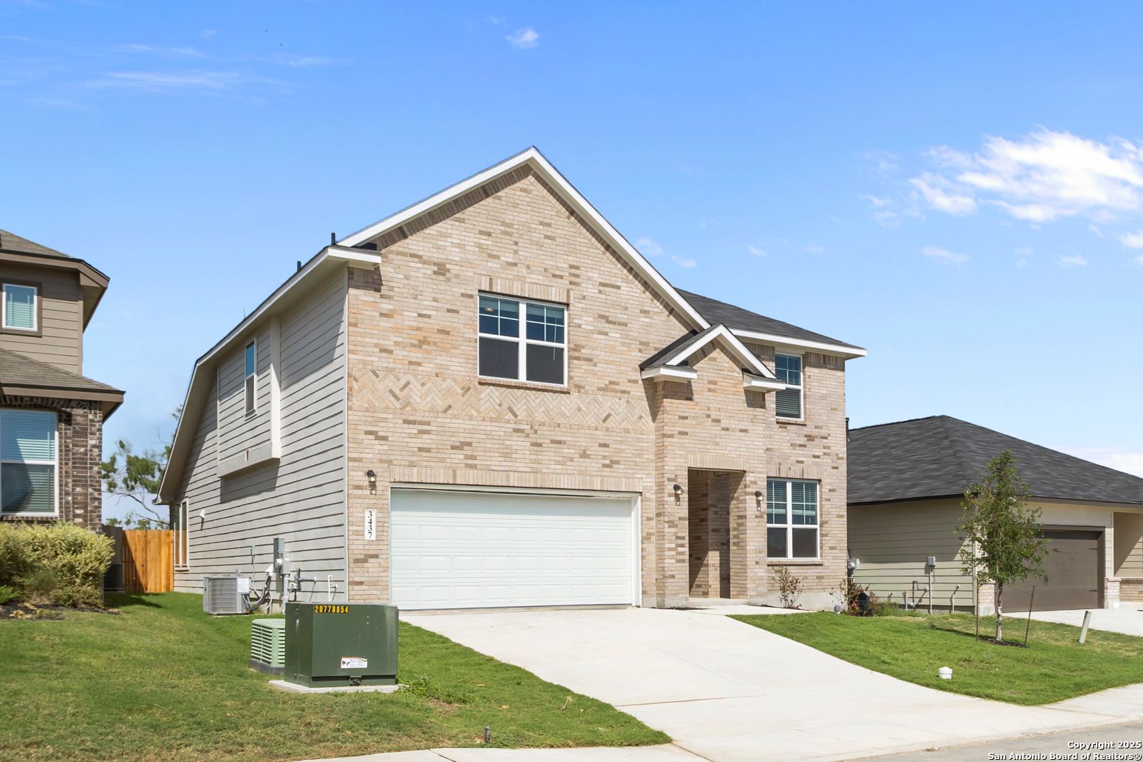 Modern two-story beige brick home with 2-car garage, driveway, and manicured lawn in Horizon Pointe, Converse, Texas - Davidson Homes Sequoia A