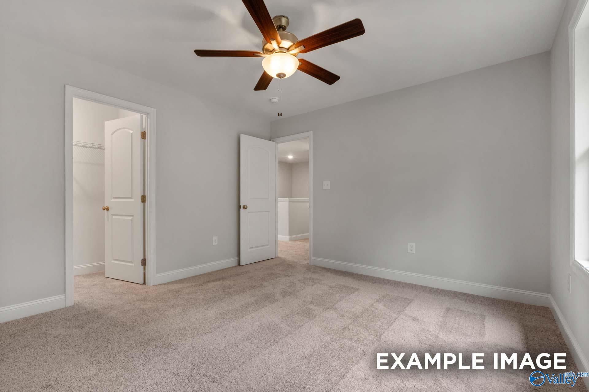 Spacious bedroom with ceiling fan, open closet, and bath access in Davidson Homes The Shelby C, The Highlands, Arab, Alabama