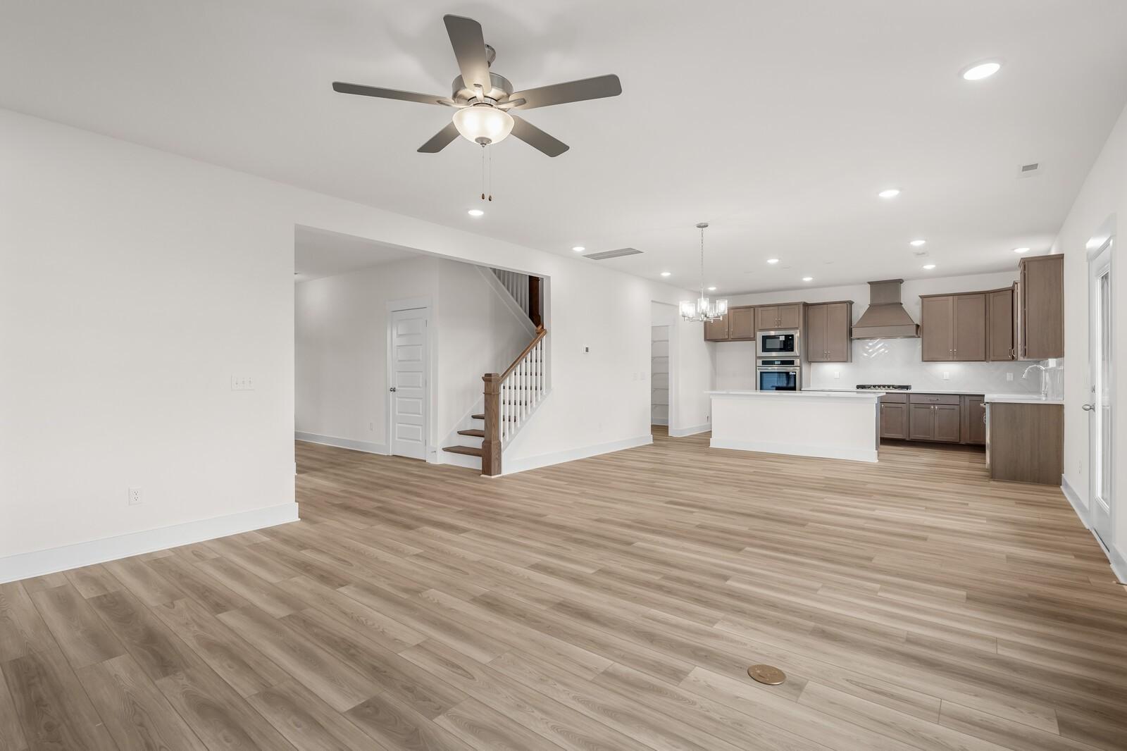 Open-concept living room and kitchen in The Henry C floor plan at Benders Cove, Mt. Juliet, Tennessee.