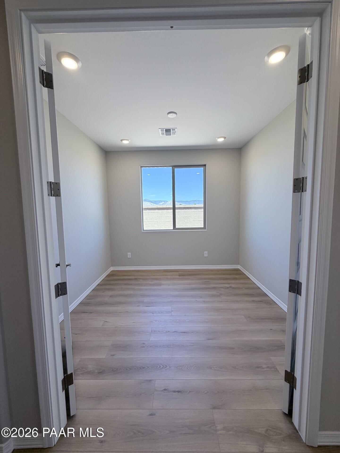 Bright flex room with wood-look flooring in The Frontier A floor plan at North Ridge, Pronghorn Ranch, Prescott Valley.