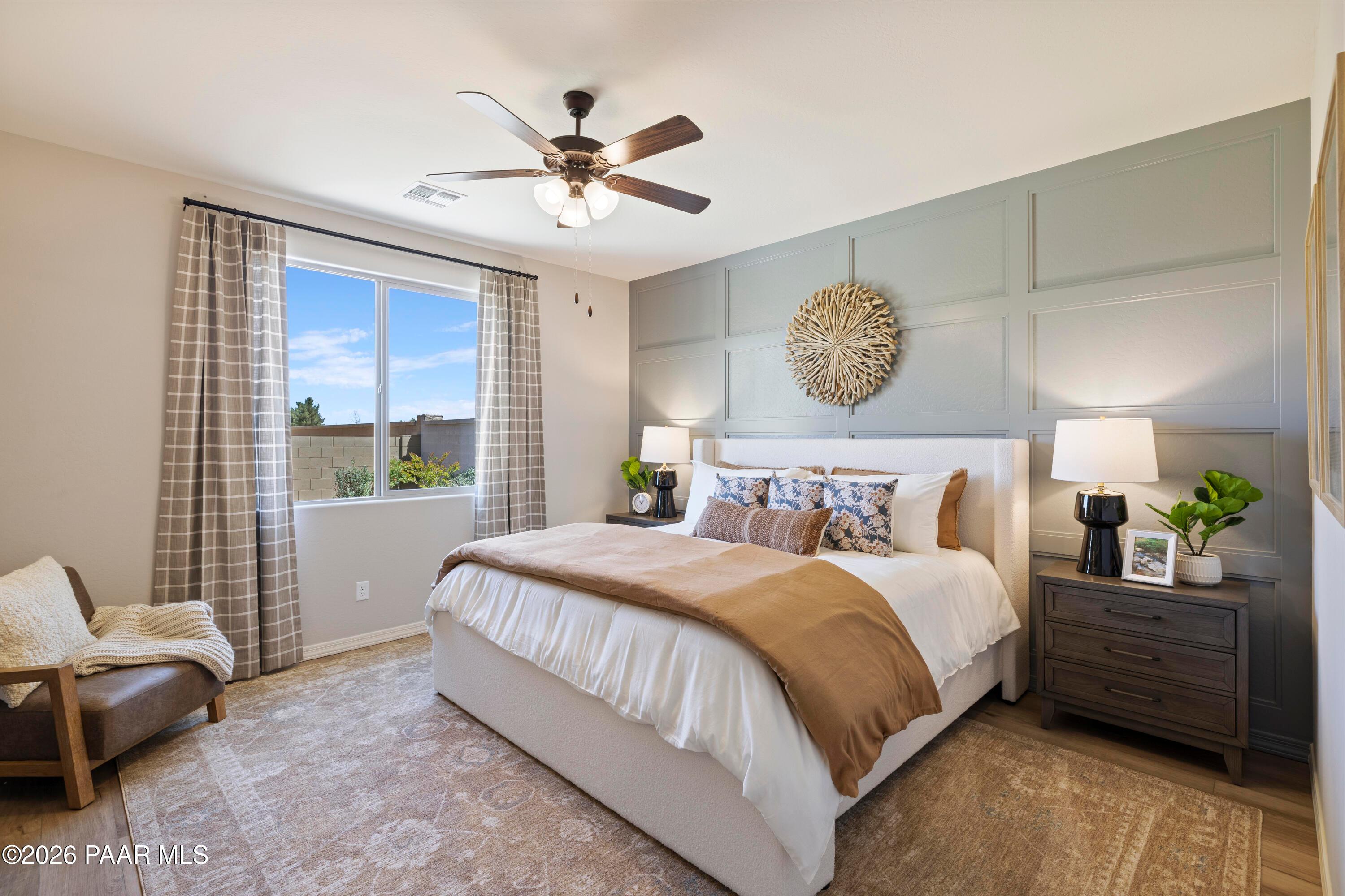 Primary bedroom with accent wall in The Harmony A floor plan at North Ridge, Pronghorn Ranch, Prescott Valley, Arizona.