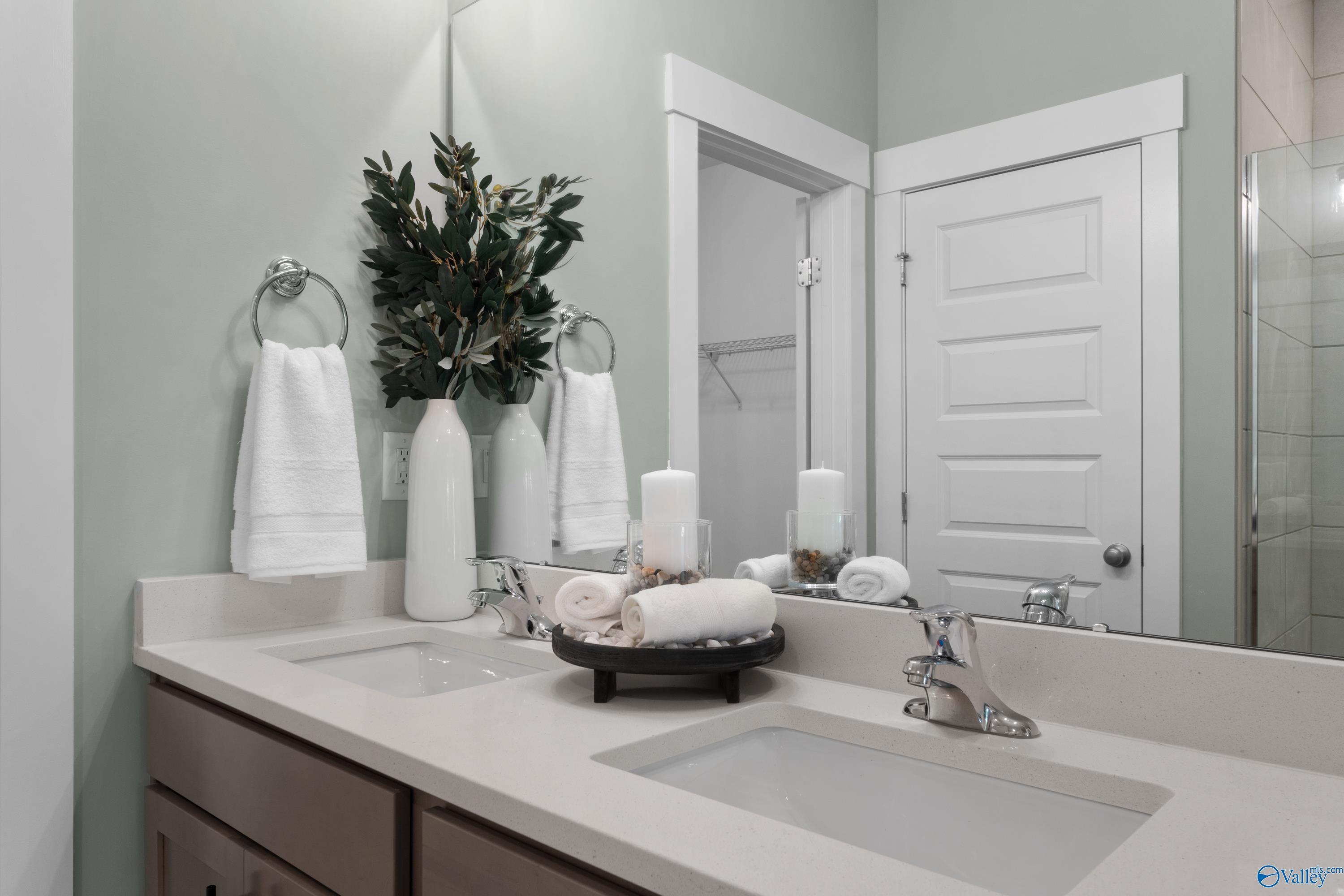 Modern double vanity bathroom with quartz countertops in The Franklin floor plan by Davidson Homes, Decatur, Alabama.