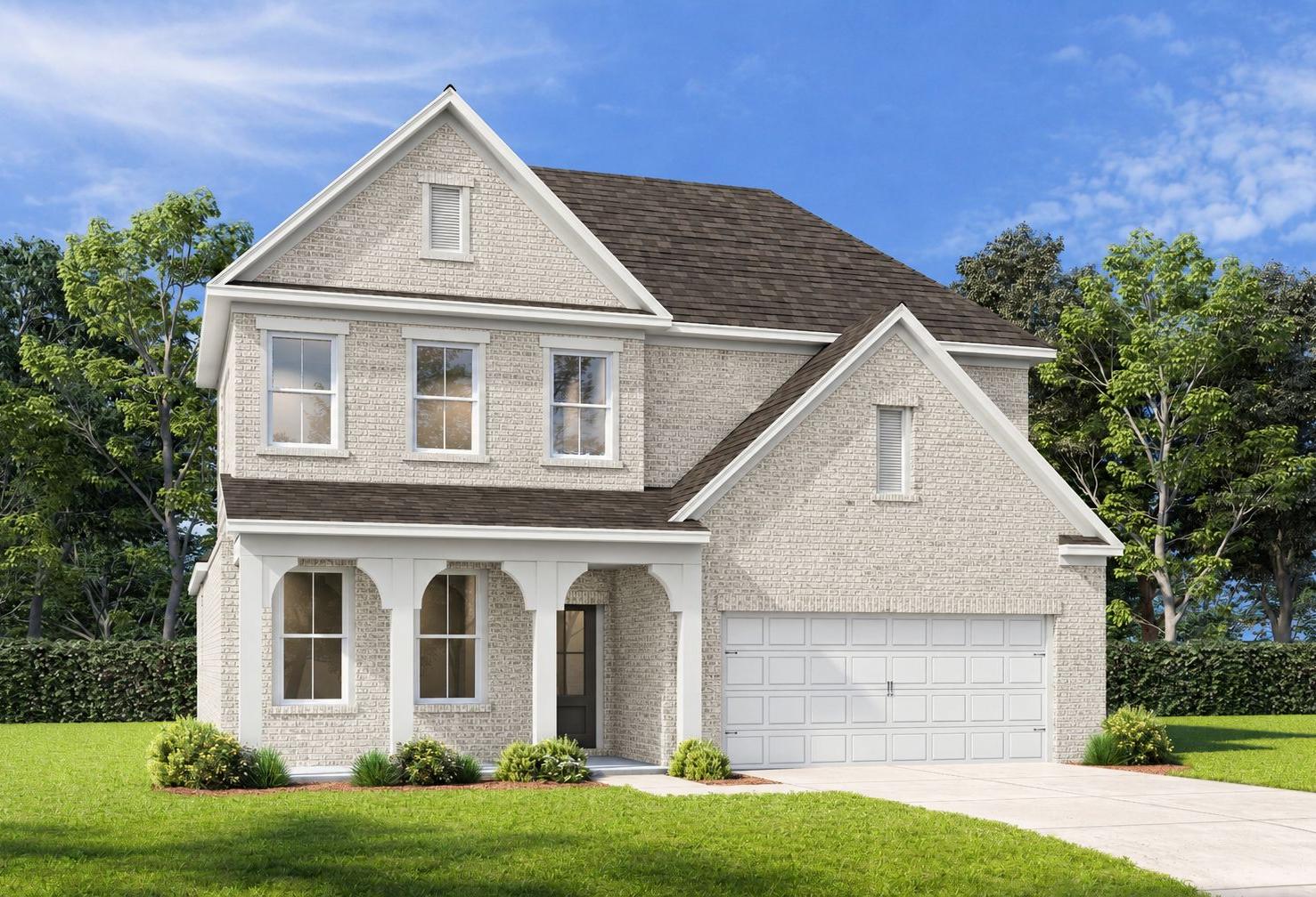 Craftsman-style exterior of The Ashport G featuring light brick, covered front porch, and a 2-car garage in Buford, GA.