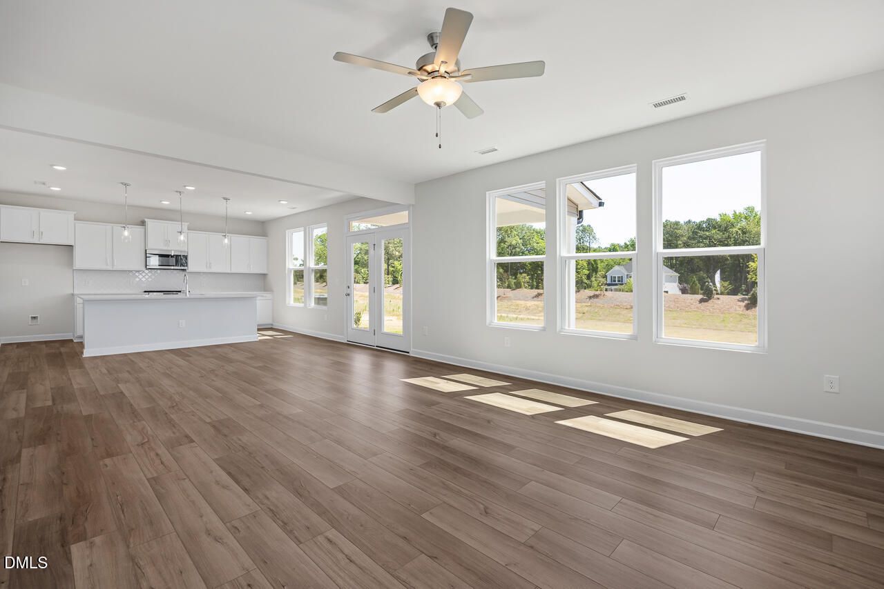 Open-concept living room and kitchen in The Chestnut B floor plan at Retreat at North Main, Lillington, North Carolina.