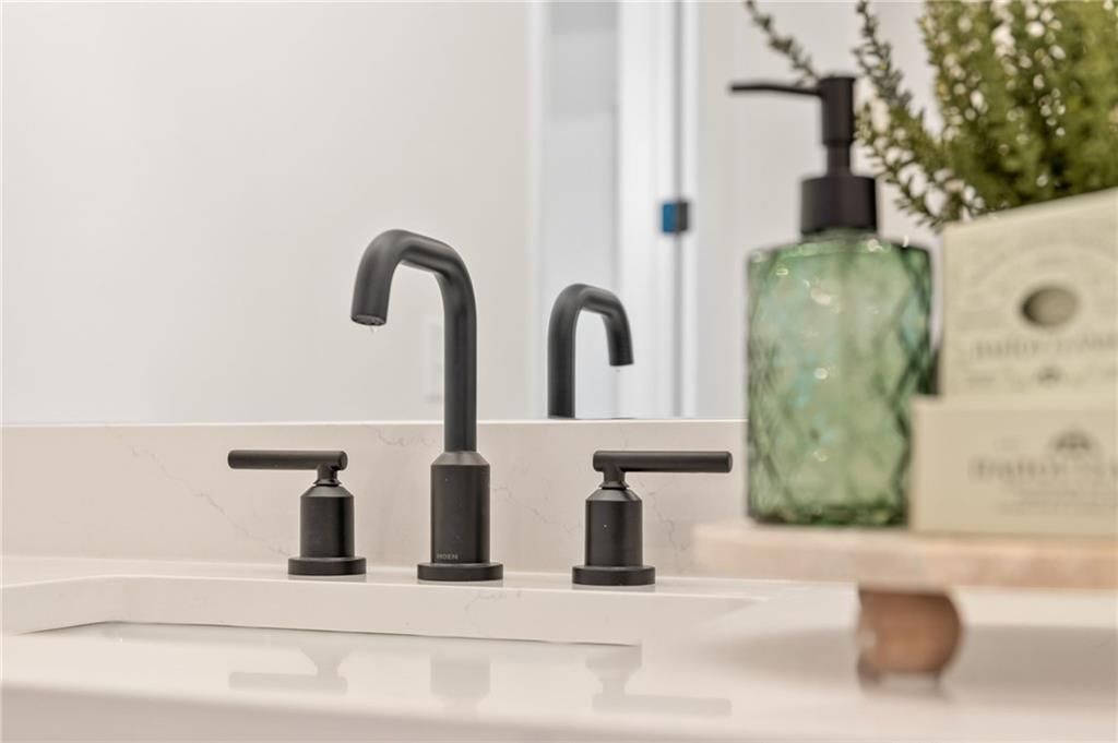 Matte black bathroom faucet on white quartz countertop in The Aspen C floor plan by Davidson Homes in Buford, Georgia.