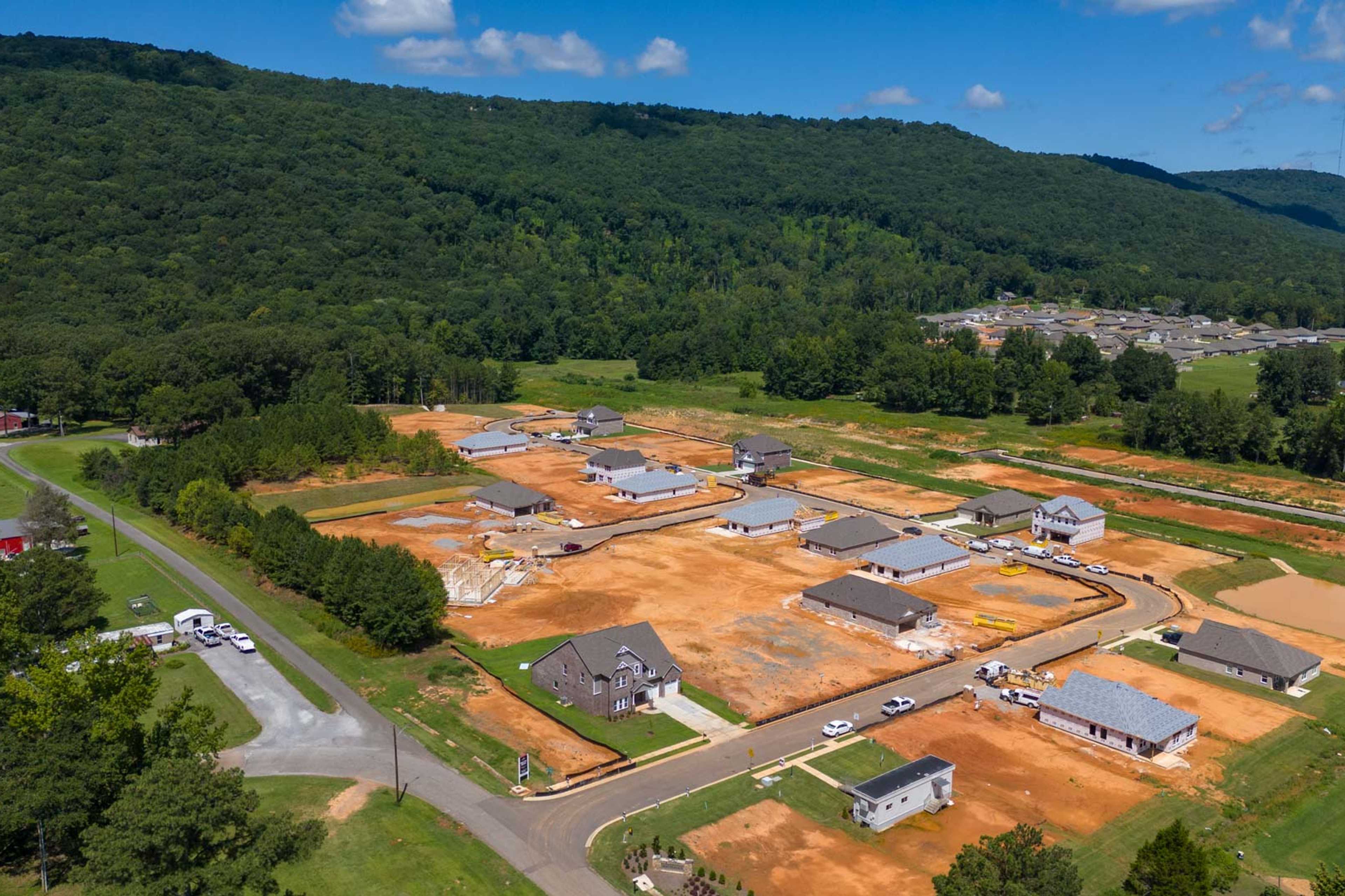 Aerial view of Watts Glen new homes under construction in Owens Cross Roads Alabama by Davidson Homes amid green forested hills