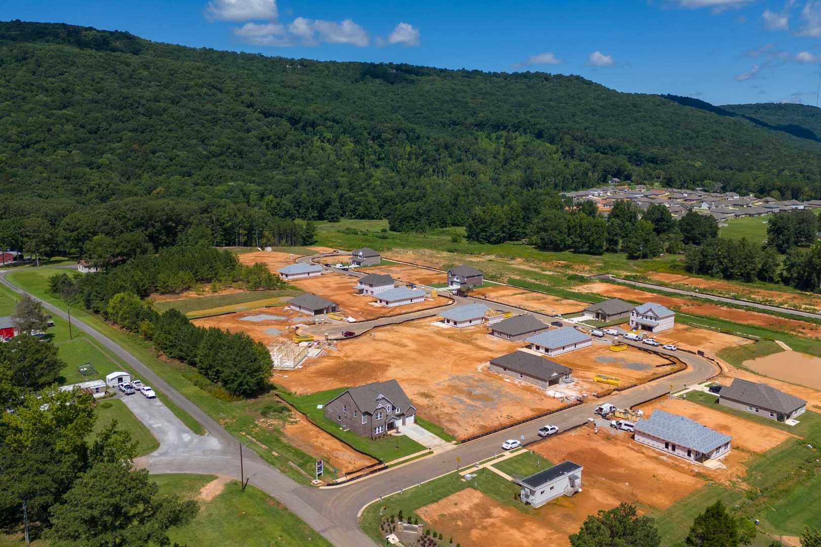 Aerial view of Watts Glen new homes under construction in Owens Cross Roads Alabama by Davidson Homes amid green forested hills