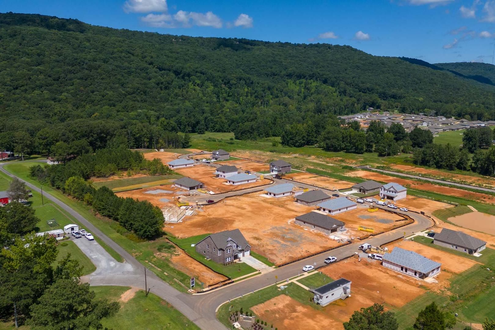 Aerial view of Watts Glen new homes under construction in Owens Cross Roads Alabama by Davidson Homes amid green forested hills