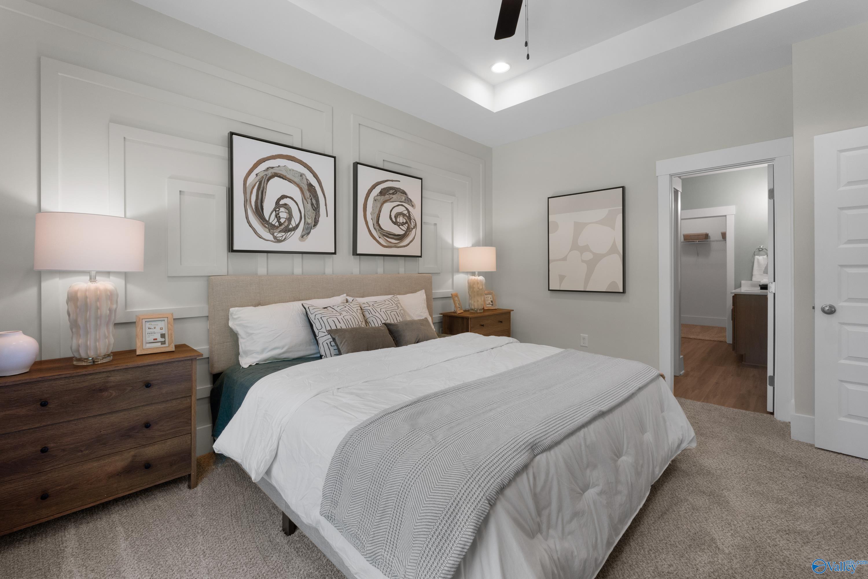 Primary bedroom with tray ceiling and en suite bathroom in The Franklin floor plan by Davidson Homes in Decatur, Alabama.