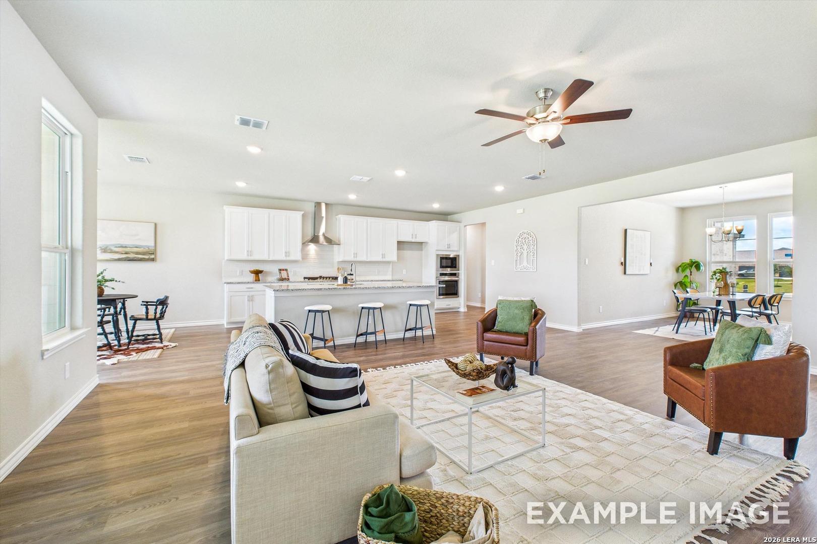 Open-concept living room and kitchen in The Foster F floor plan by Davidson Homes in Potranco Oaks, Castroville, Texas.