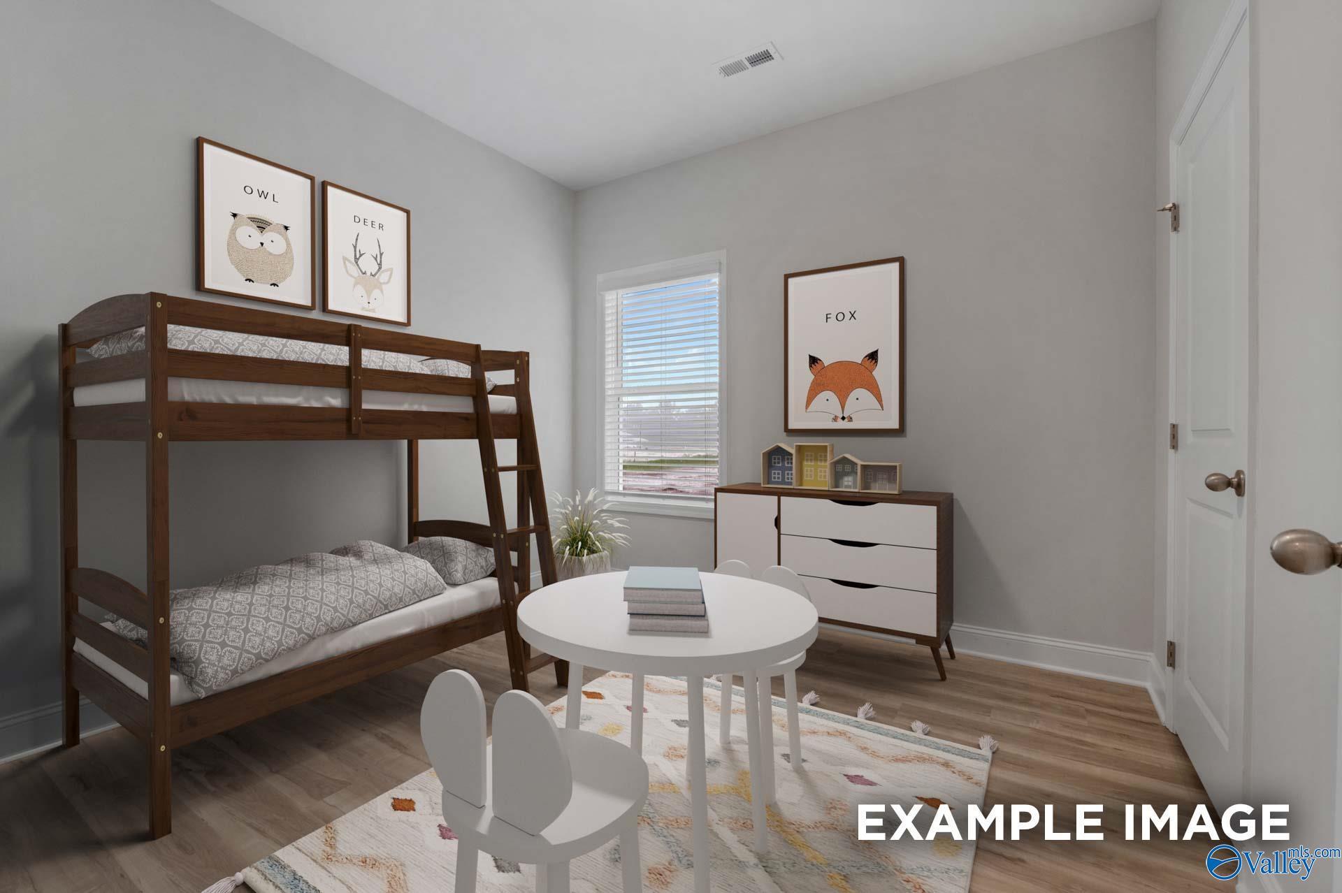 Cozy kids' bedroom with wooden bunk beds, owl and fox wall art, round table and chairs in Davidson Homes The Cumberland B, Decatur, Alabama