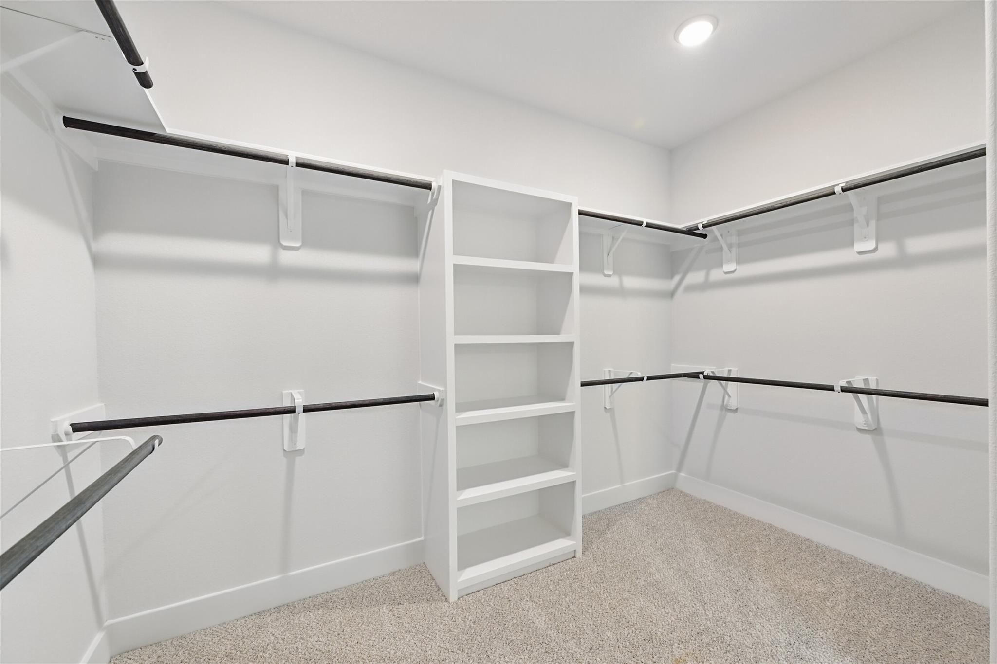 Spacious walk-in closet with built-in shelves and hanging rods in master suite, Davidson Homes The Philip A, Lago Mar, Texas City