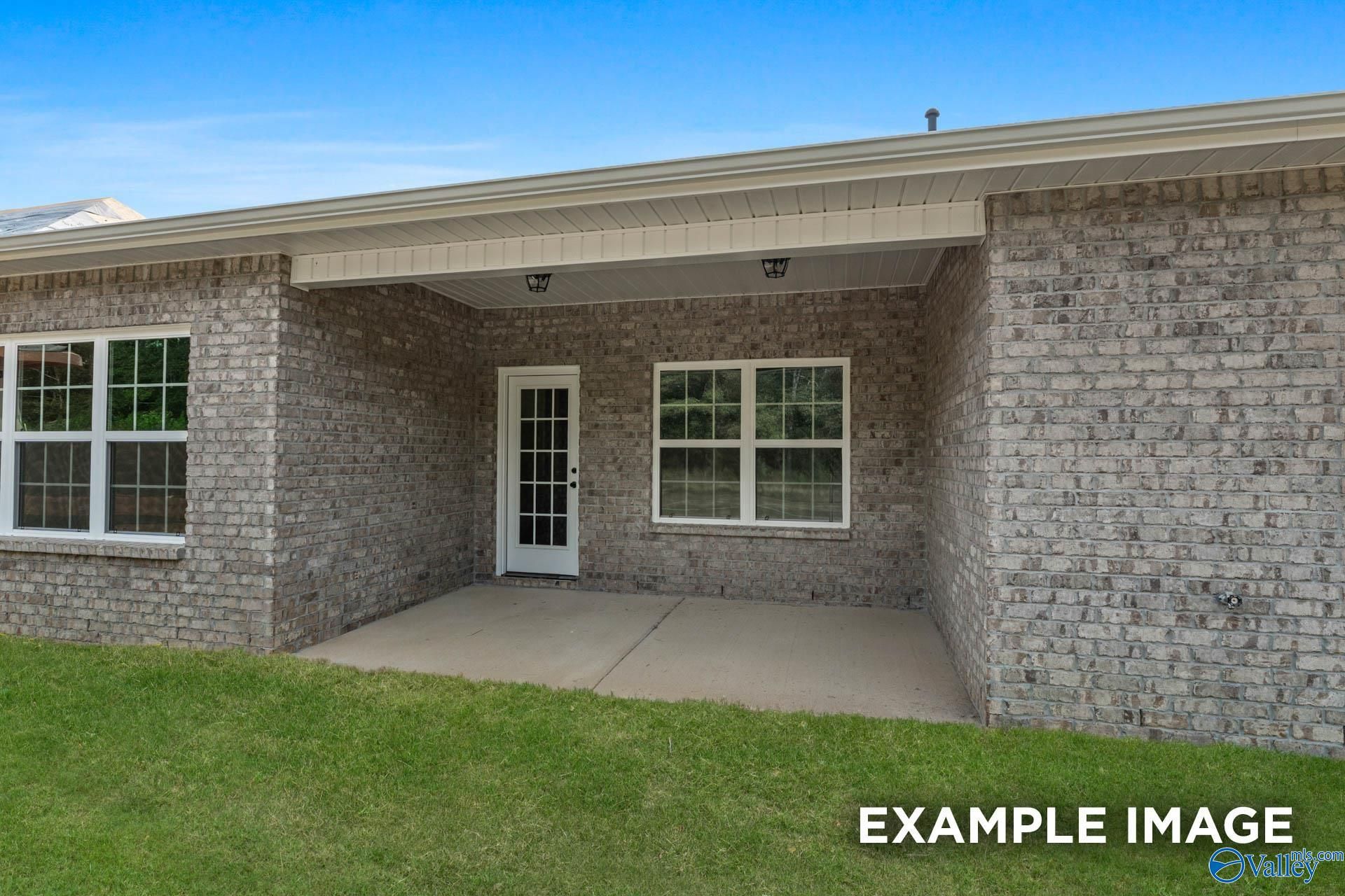 Covered back patio with French doors on brick exterior, The Montgomery B by Davidson Homes in Kendall Downs, Toney, Alabama