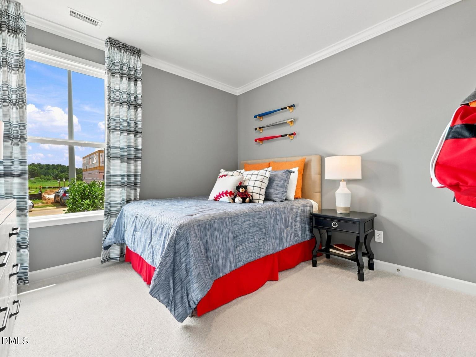 Cozy secondary bedroom with baseball decor in The Daphne C floor plan at Woodland Crossing, Zebulon, North Carolina.