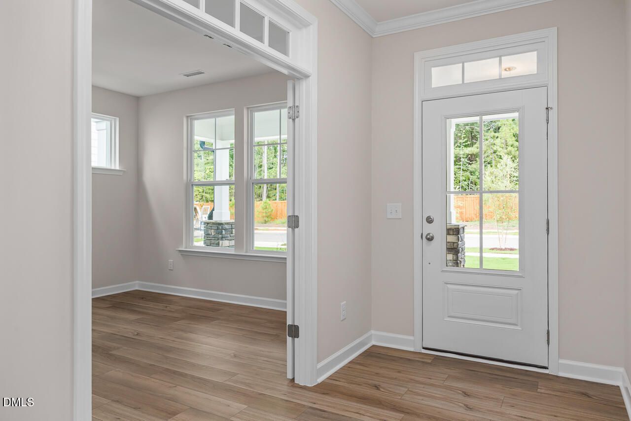 Bright home office with glass-paneled French doors and wood flooring in The Hickory II C floor plan, Montrose, Aberdeen, NC.