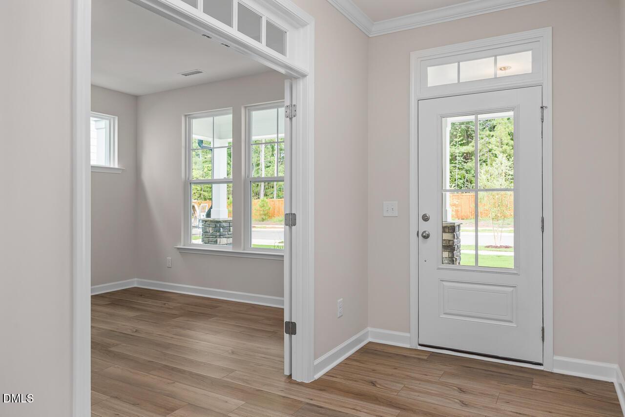Bright home office with glass-paneled French doors and wood flooring in The Hickory II C floor plan, Montrose, Aberdeen, NC.