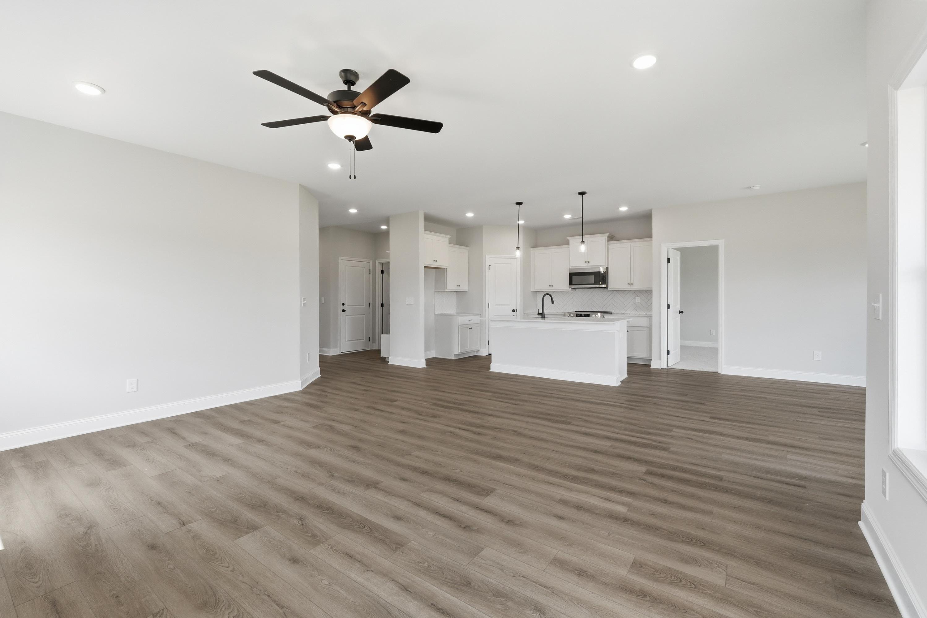 Open-concept living area and kitchen with white cabinetry in The Glen B floor plan by Davidson Homes.