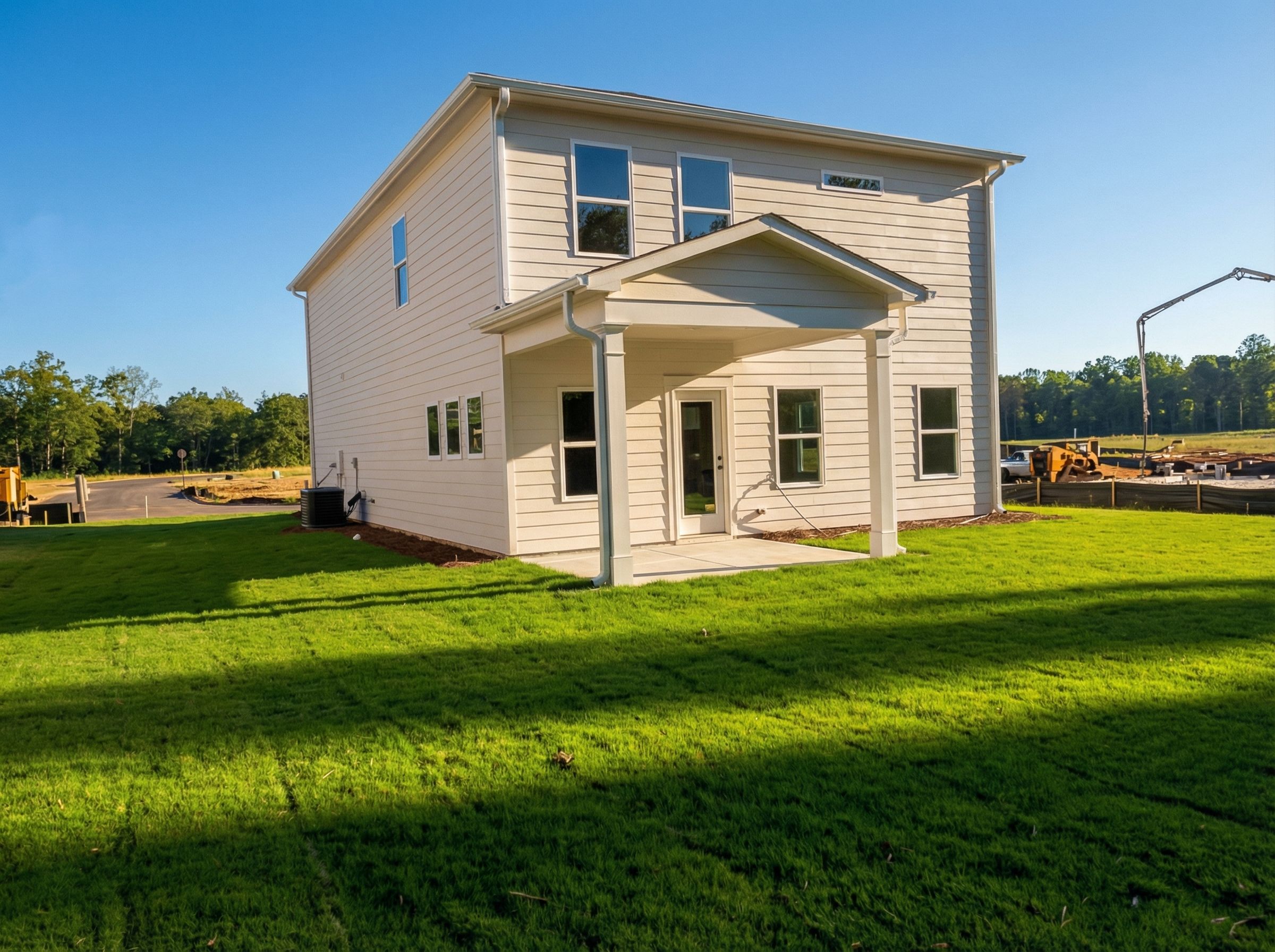 Two-story white Rabun C home by Davidson Homes in Cedar Farms, Winder, Georgia, featuring covered front porch and large windows