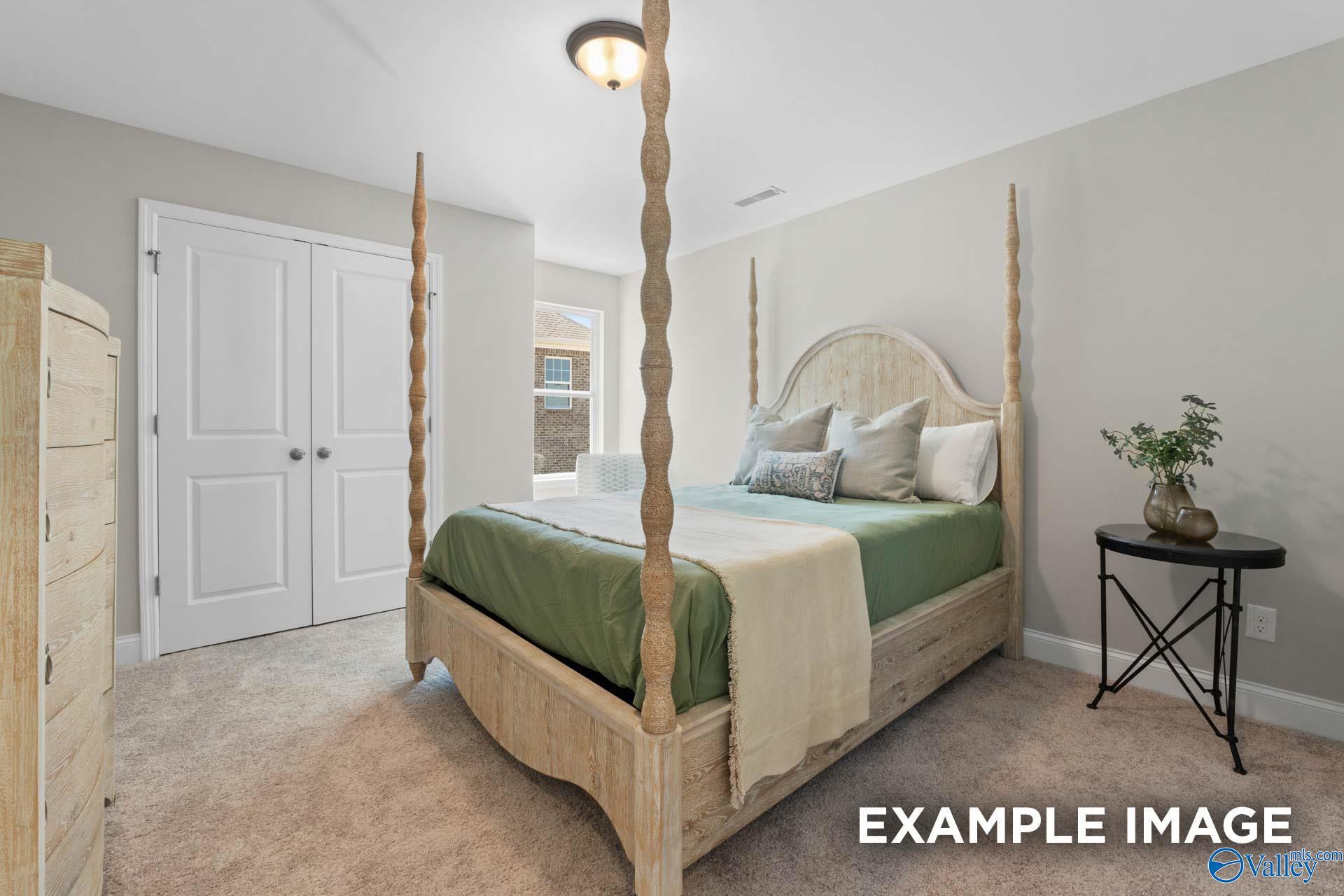 Serene four-poster bed with rattan posts, green bedding, and potted plant in light gray bedroom, Evermore Homes The Haven E, Owens Cross Roads