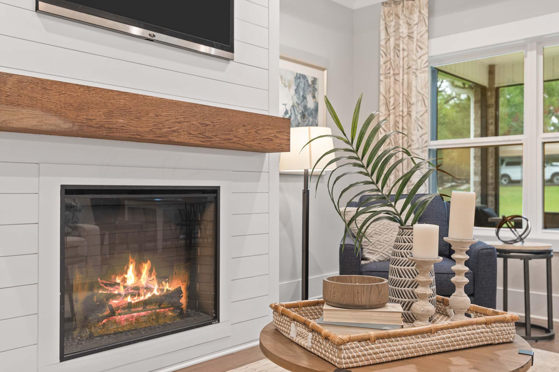 Cozy living room fireplace at Monteagle Cove in Owens Cross Roads AL with shiplap walls, wooden mantel, and modern decor accents