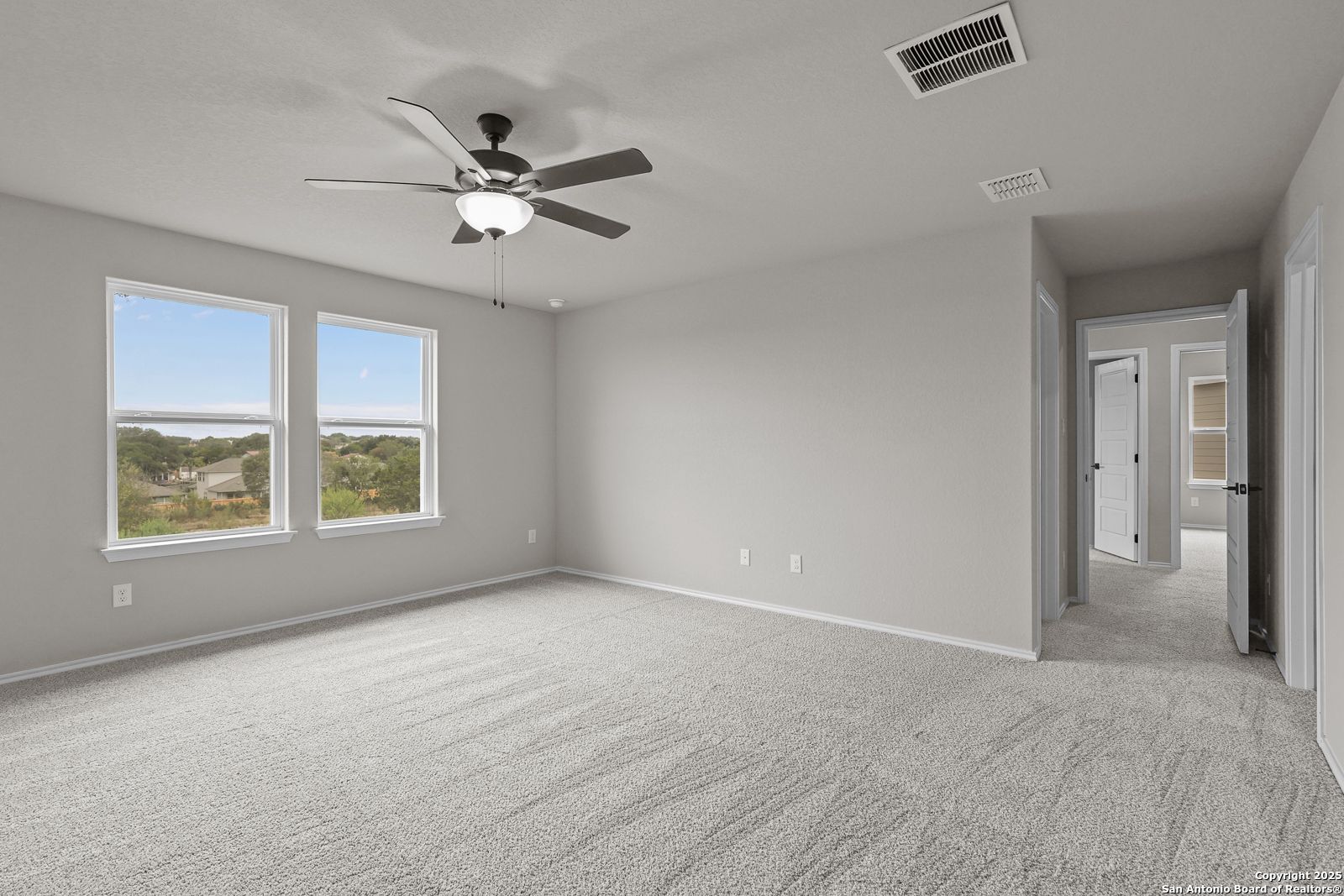 Bright bedroom with large windows and scenic Texas view in Davidson Homes The Murray J, Royal Crest, San Antonio