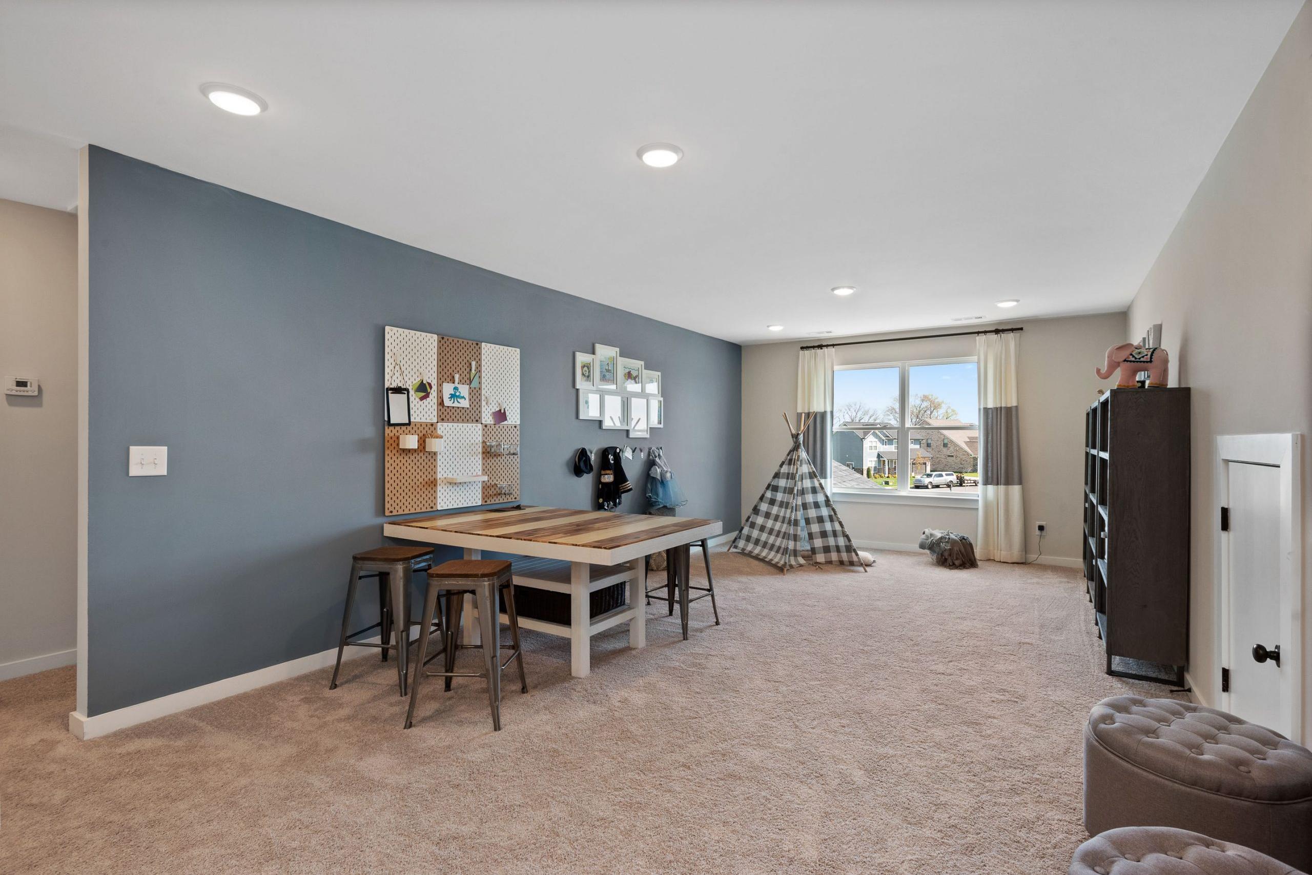 Children's playroom at Rivers Edge in Murfreesboro TN with teepee tent, wooden table, corkboard and bookshelf