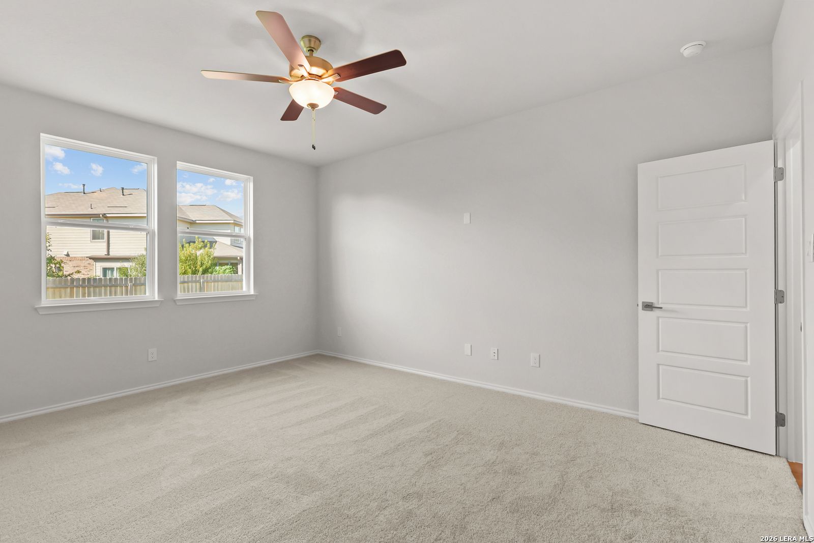 Bright bedroom with ceiling fan, carpet flooring, and dual windows in Davidson Homes The Daphne I, Bricewood, San Antonio, Texas