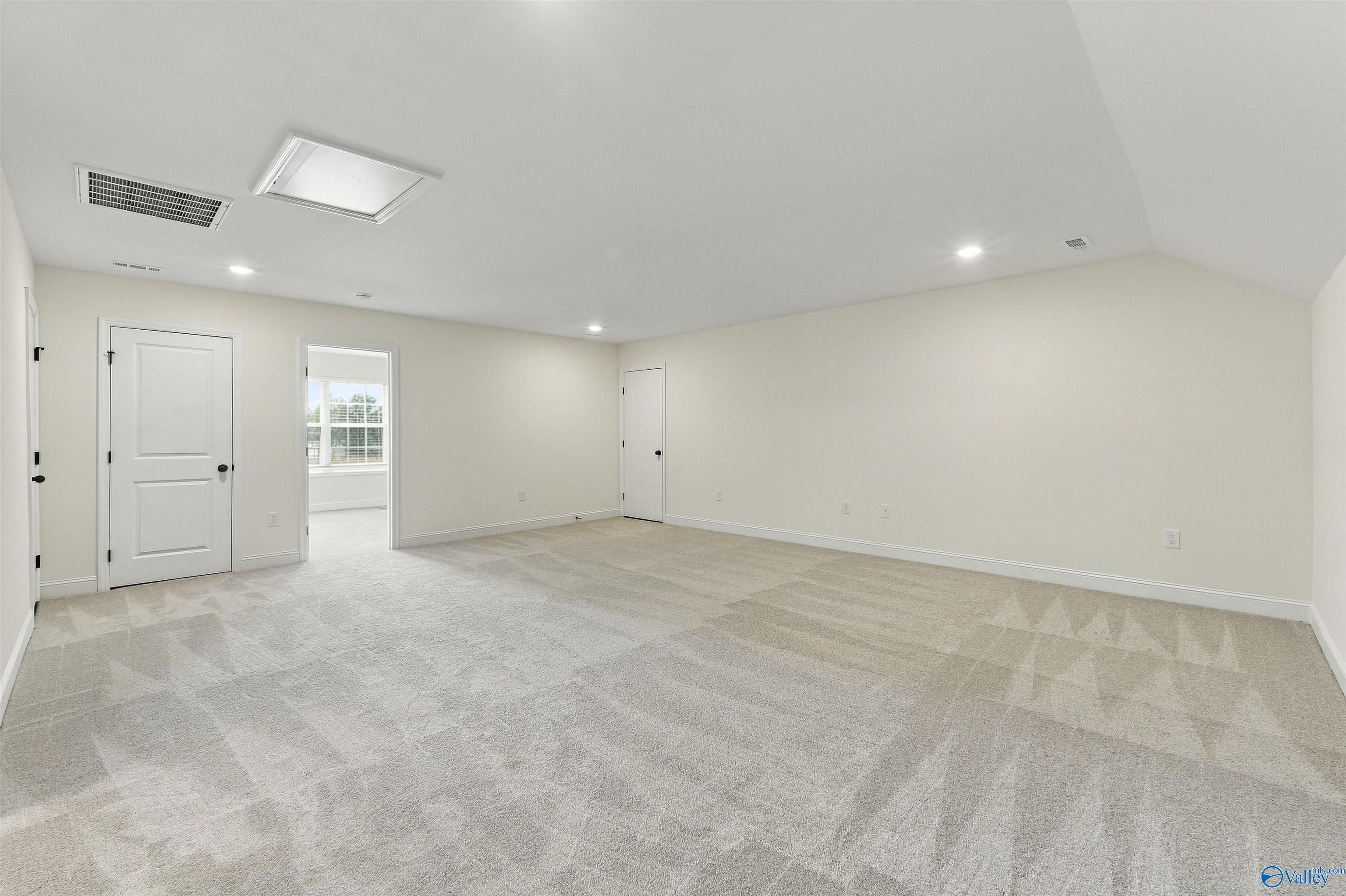 Spacious bonus room with neutral carpet and recessed lighting in Davidson Homes Valencia floor plan, Riverton Preserve, Huntsville