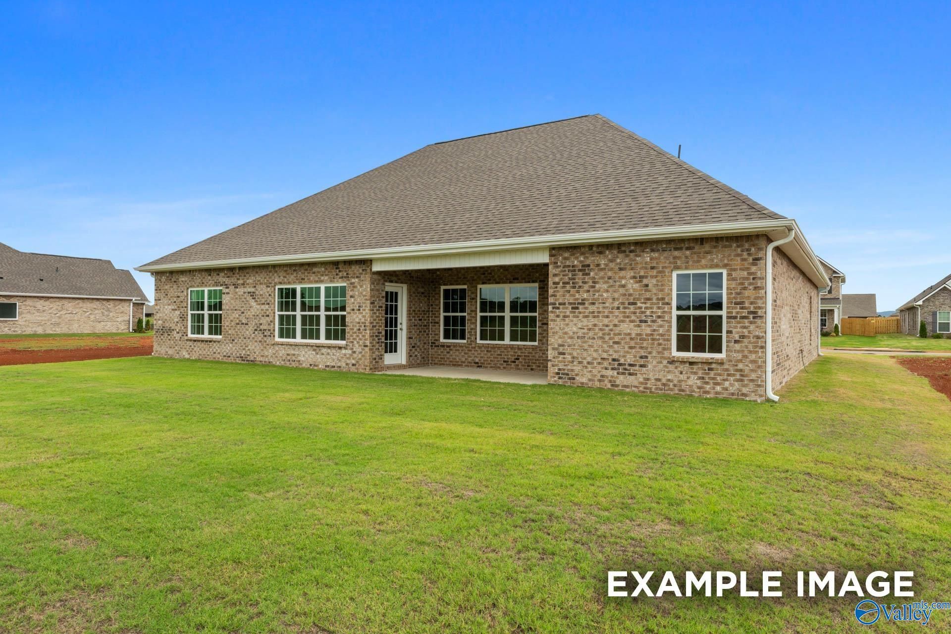 Back exterior view of The Finleigh floor plan home with brick siding and covered patio in Briercreek, Meridianville, AL.