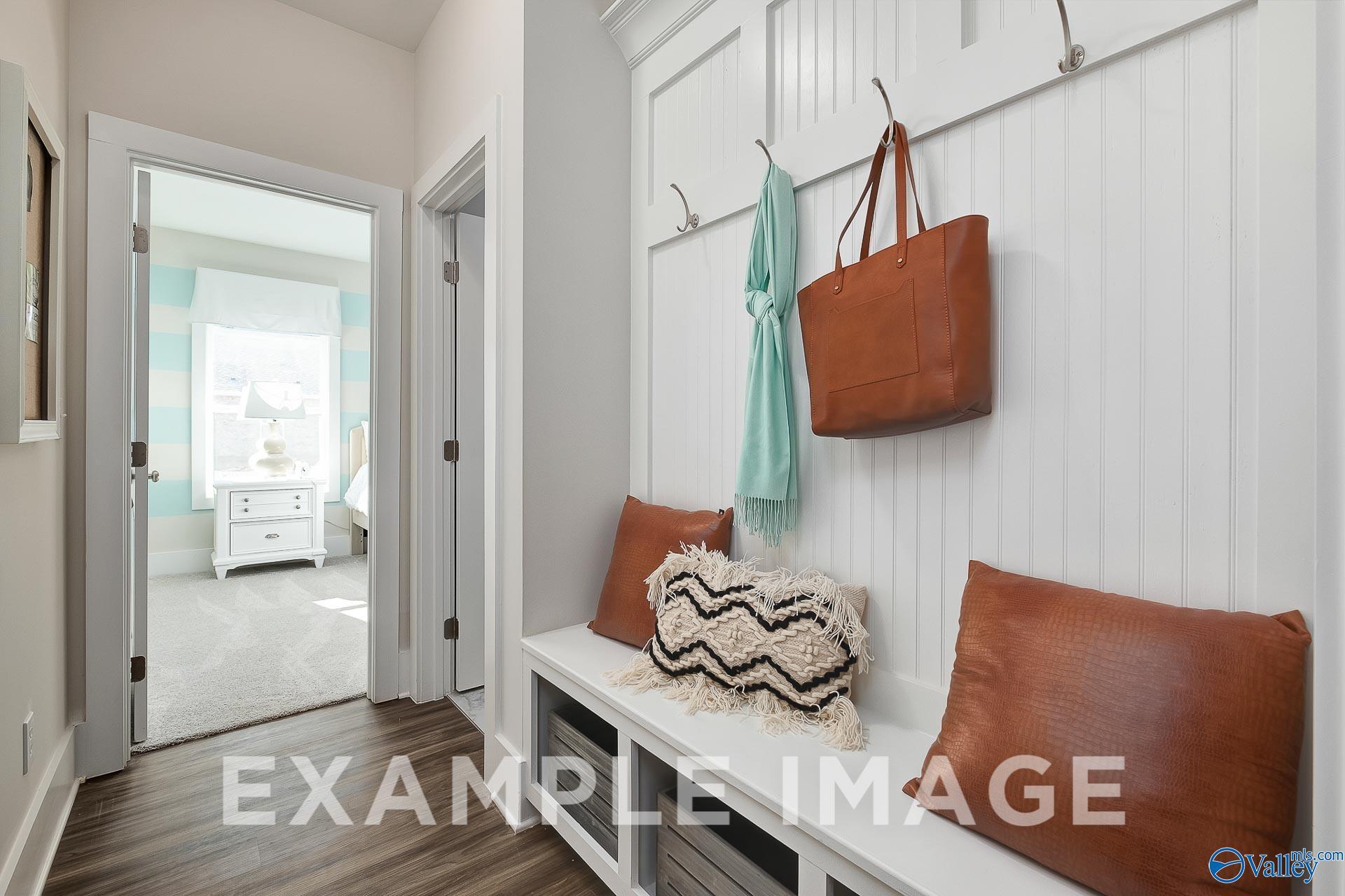 Mudroom bench with beadboard wall and hooks in The Everett B floor plan by Davidson Homes in The Meadows, Athens, Alabama.