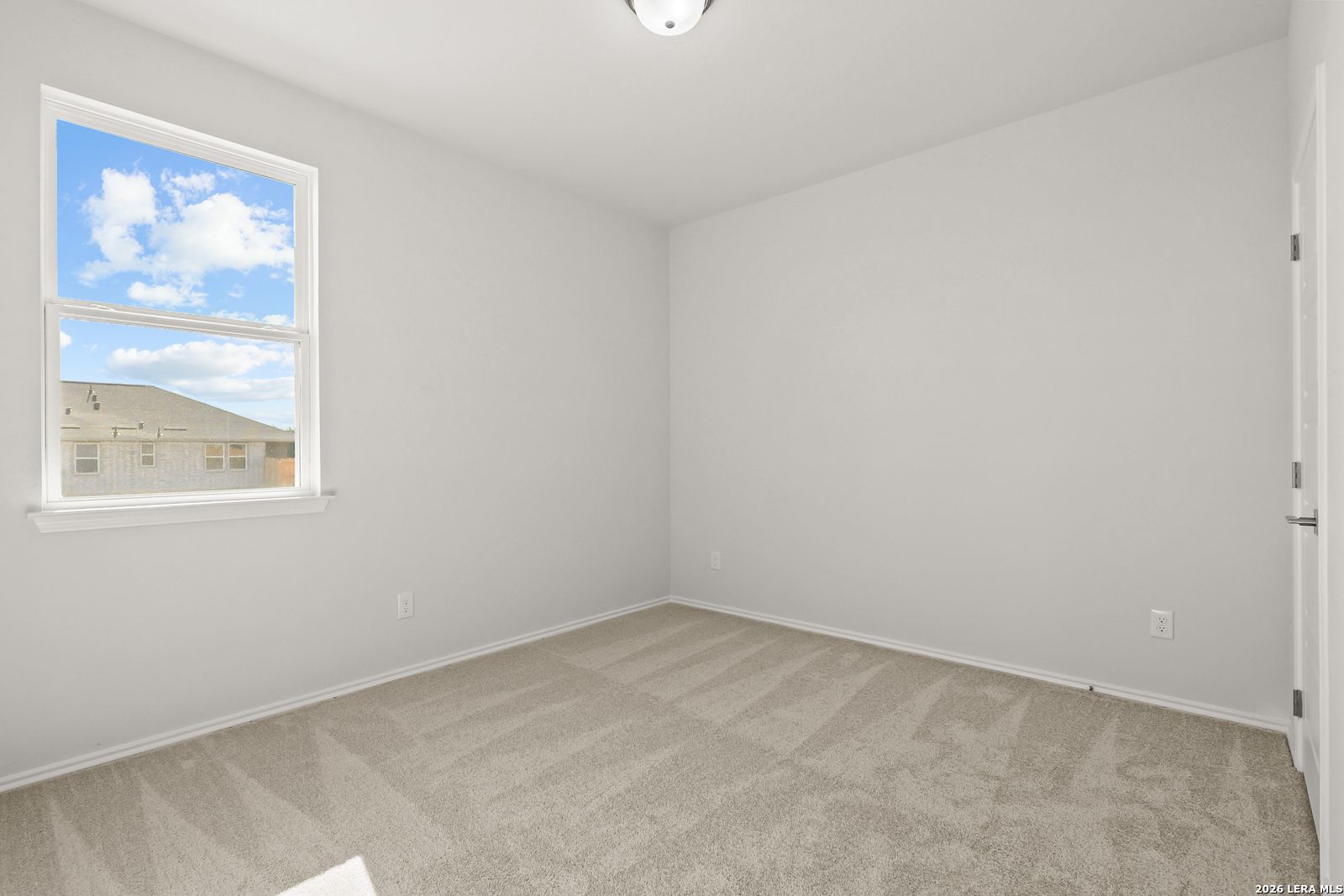 Bright empty bedroom with carpet flooring and large window in Davidson Homes The Daphne I floor plan, Bricewood, San Antonio, Texas