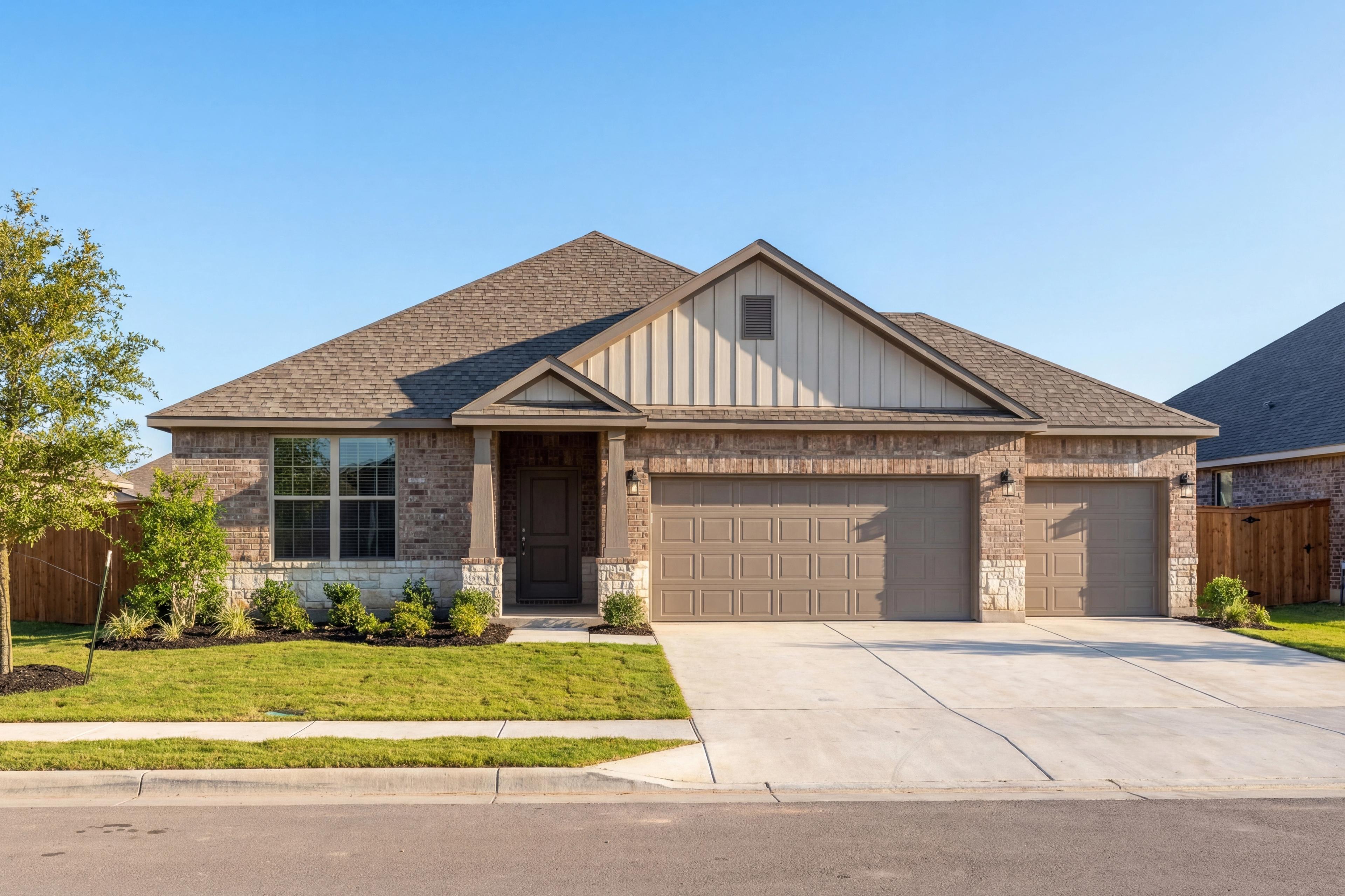 Single-story The Daphne G elevation with 3-car garage, beige siding, stone accents, and front porch in Dayton Texas