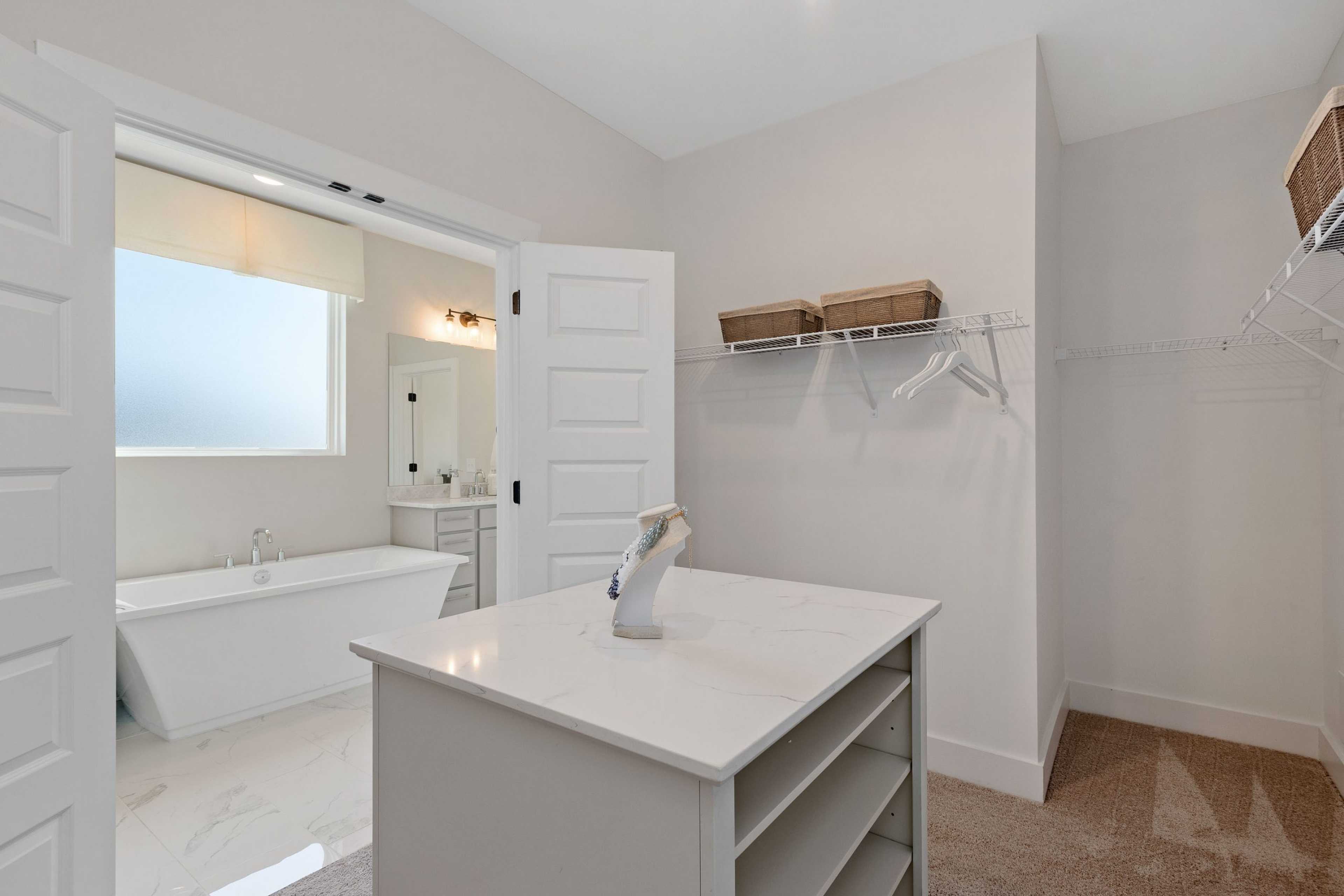 Luxurious master bathroom with freestanding tub, vanity island, and walk-in closet at Rivers Edge, Murfreesboro TN