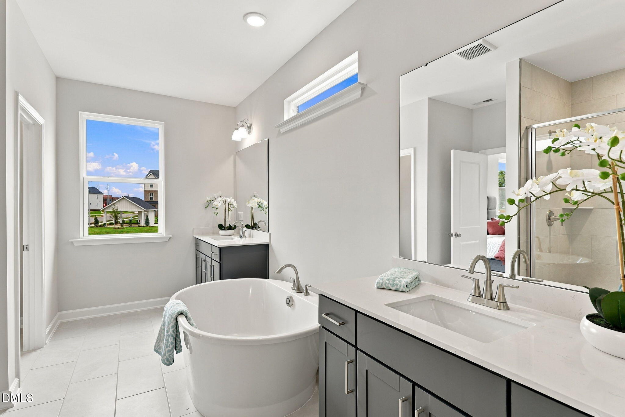Freestanding soaking tub and dual vanity in owner's bath at Forestville Yard by Davidson Homes, Knightdale, NC