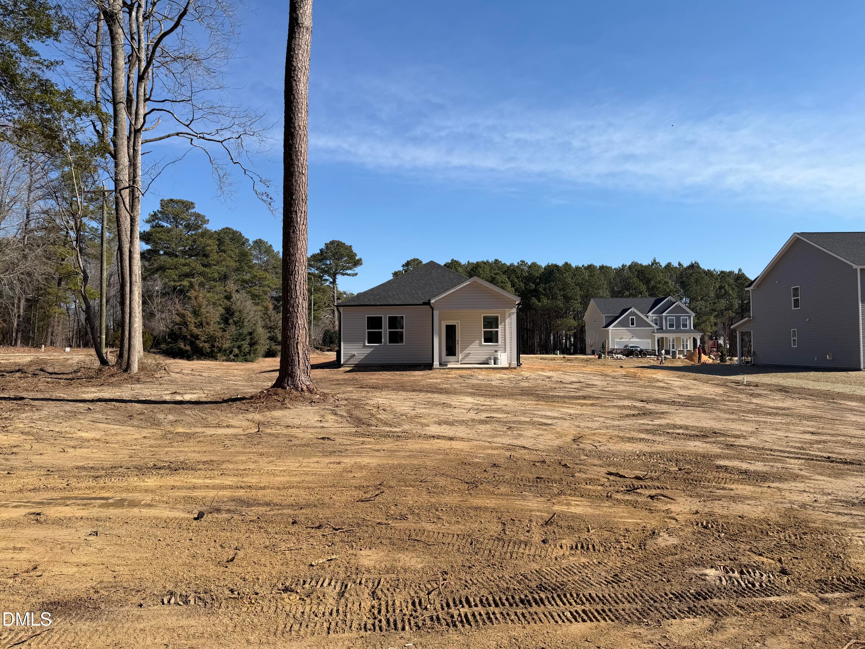 Davidson Homes The Carter C 3-bedroom single-story exterior amid pine trees in Wellers Knoll, Lillington, North Carolina